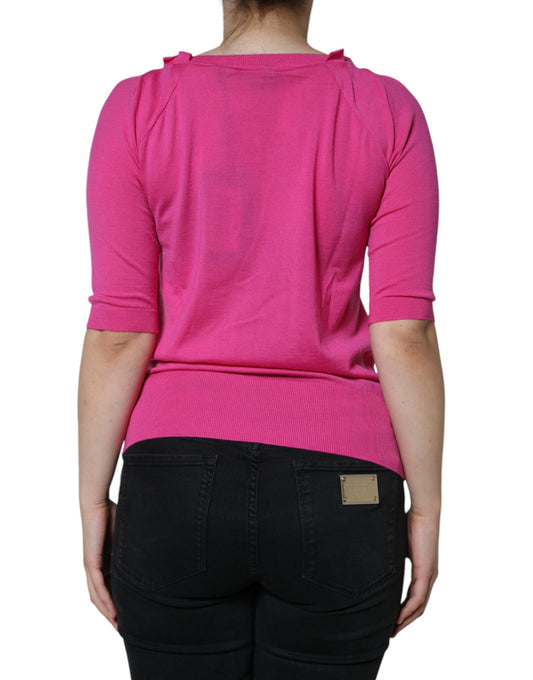 Woman wearing pink sweater and black jeans