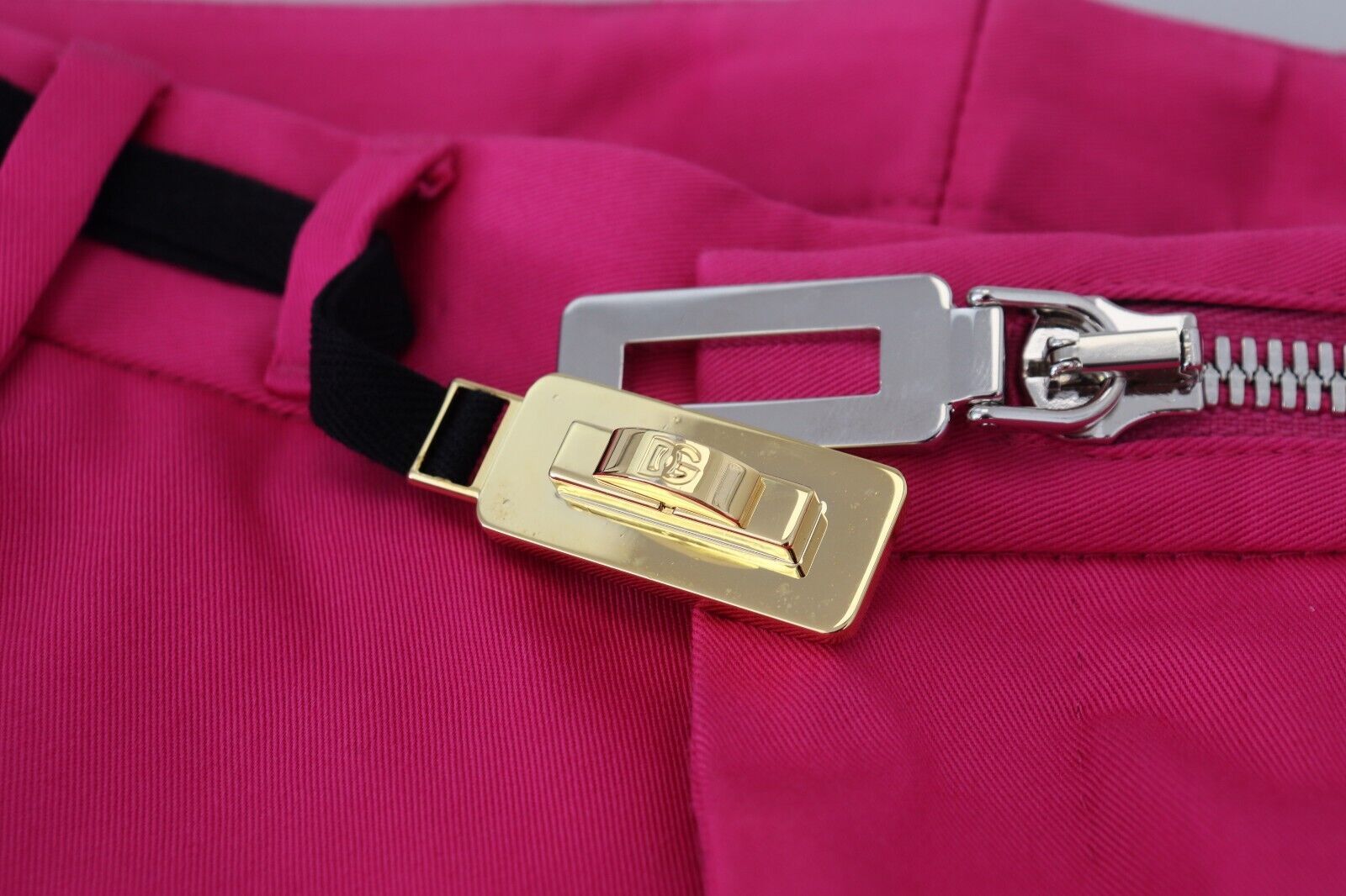 Gold key chain attached to pink fabric