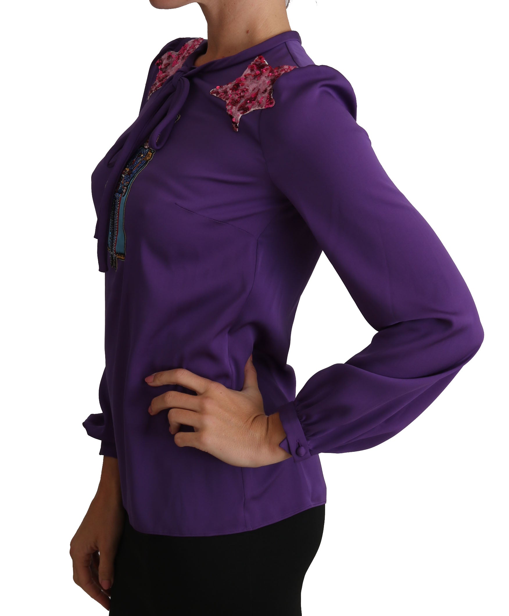 Woman wearing purple blazer with floral embellishment on left shoulder