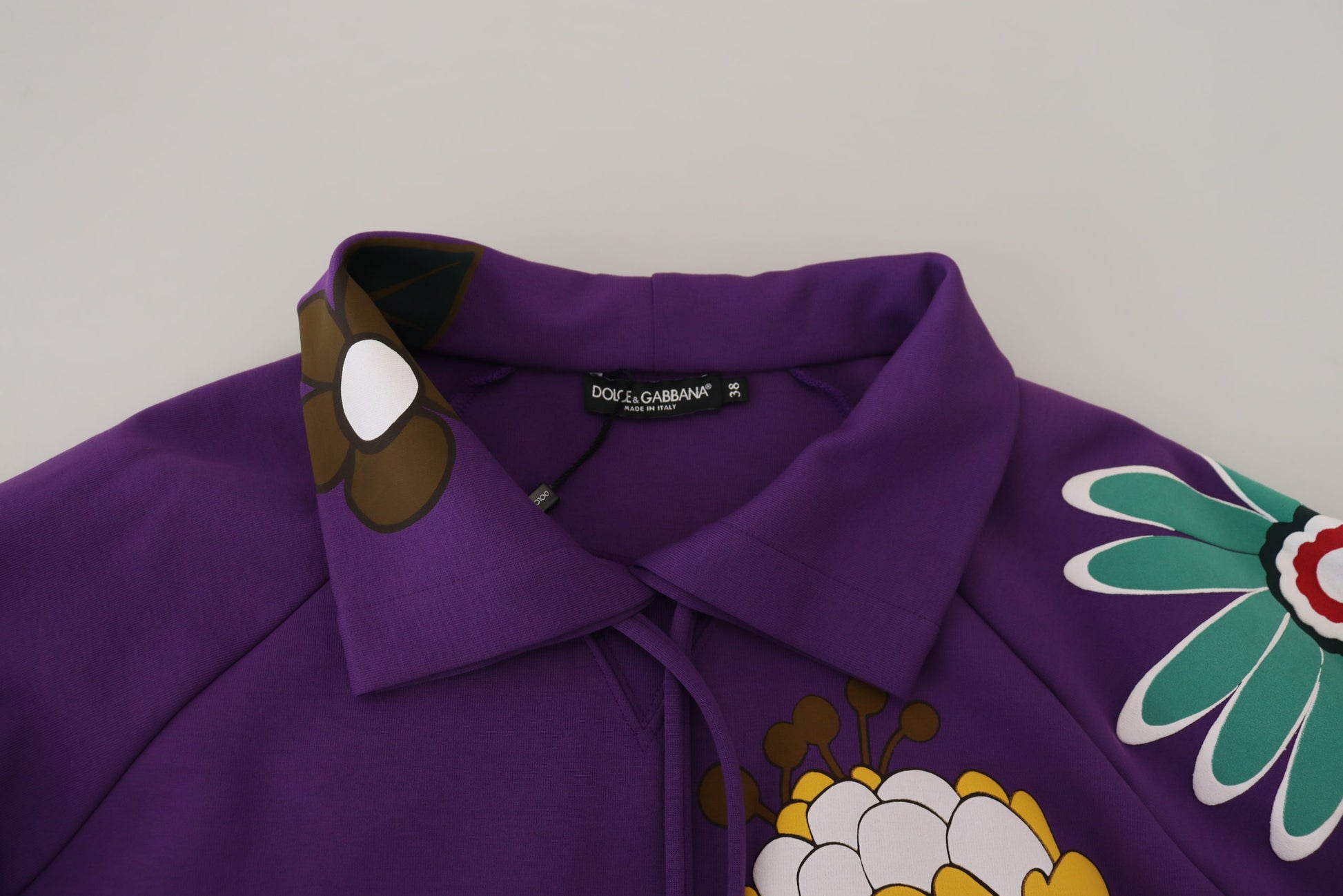 Purple polo shirt with colorful embroidery on collar