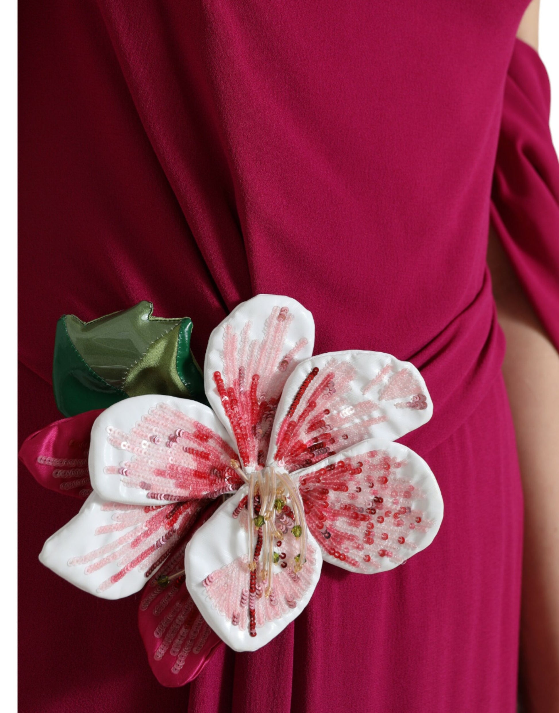 A purple dress with a flower embellishment on the shoulder
