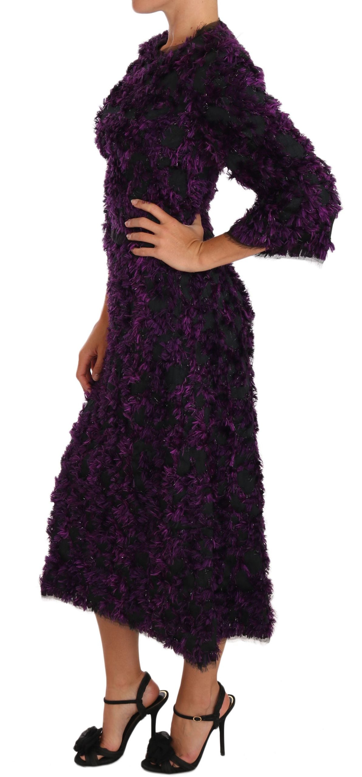 A long purple dress with fringe details, worn by a model