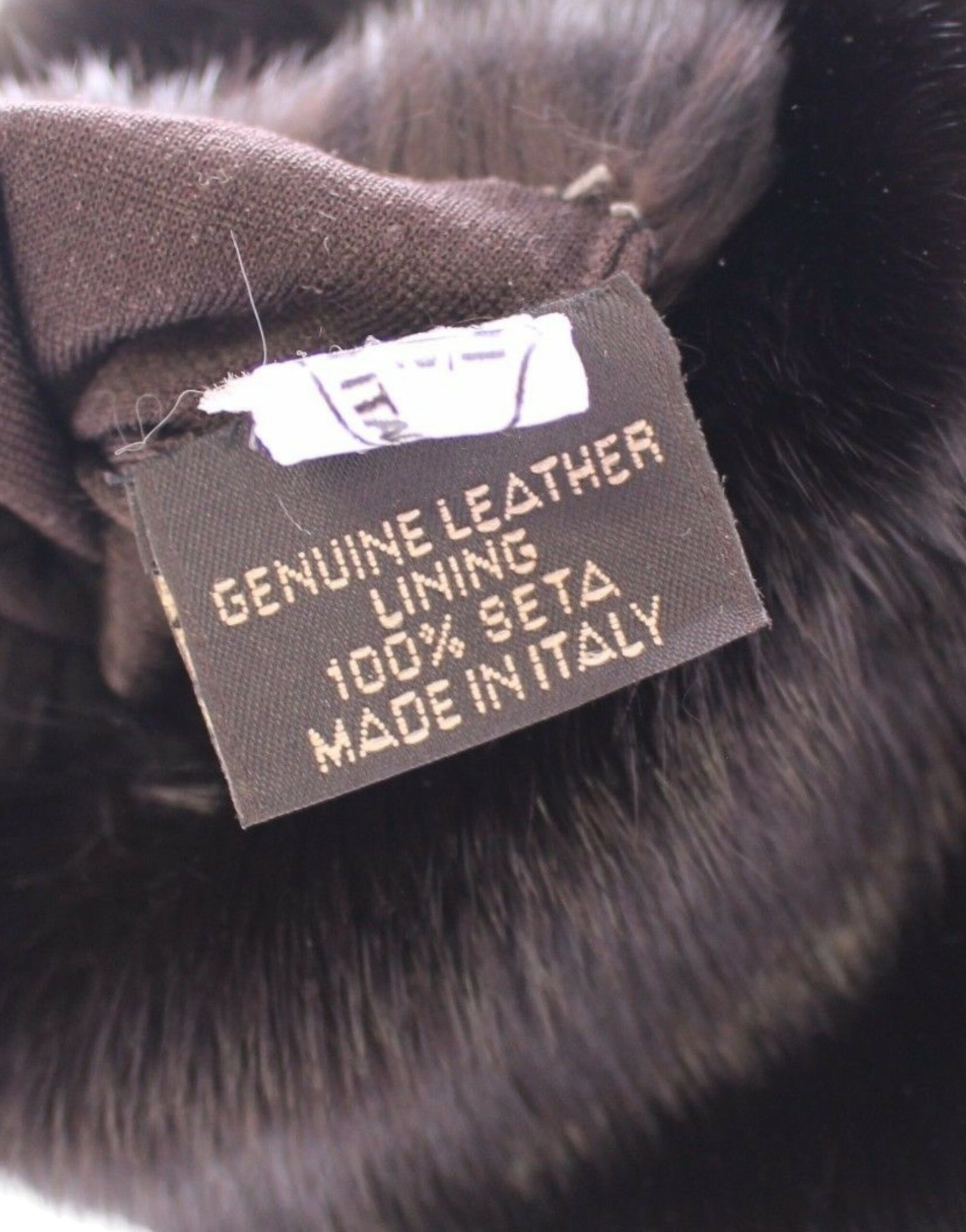 Tag on a piece of clothing indicating it is made from genuine leather