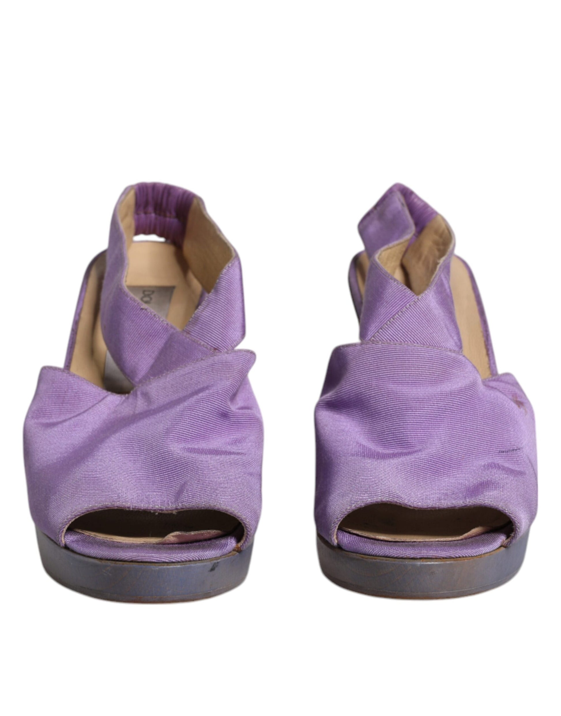 Pair of purple shoes with a bow on top