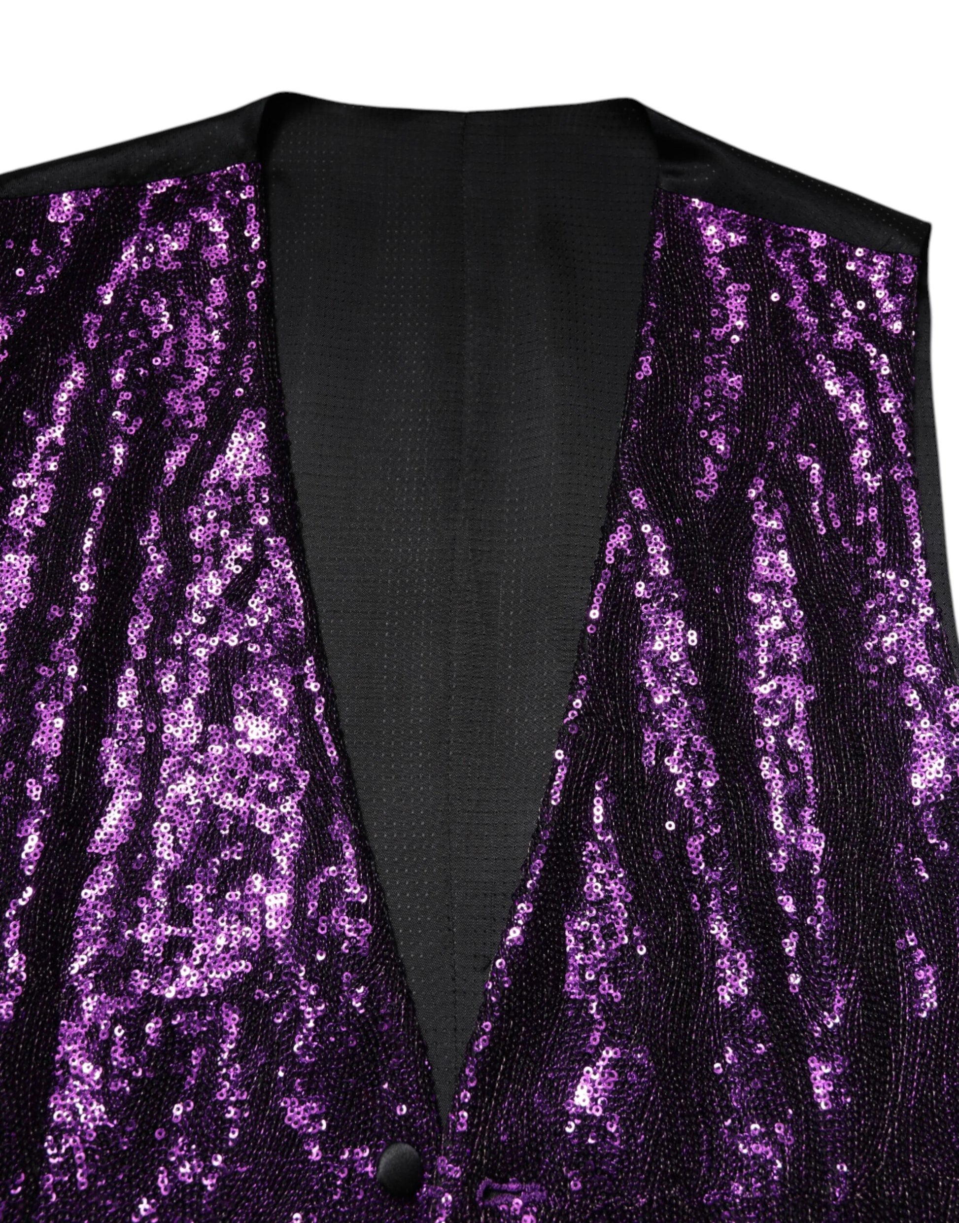 A purple sequined vest with a black shirt underneath
