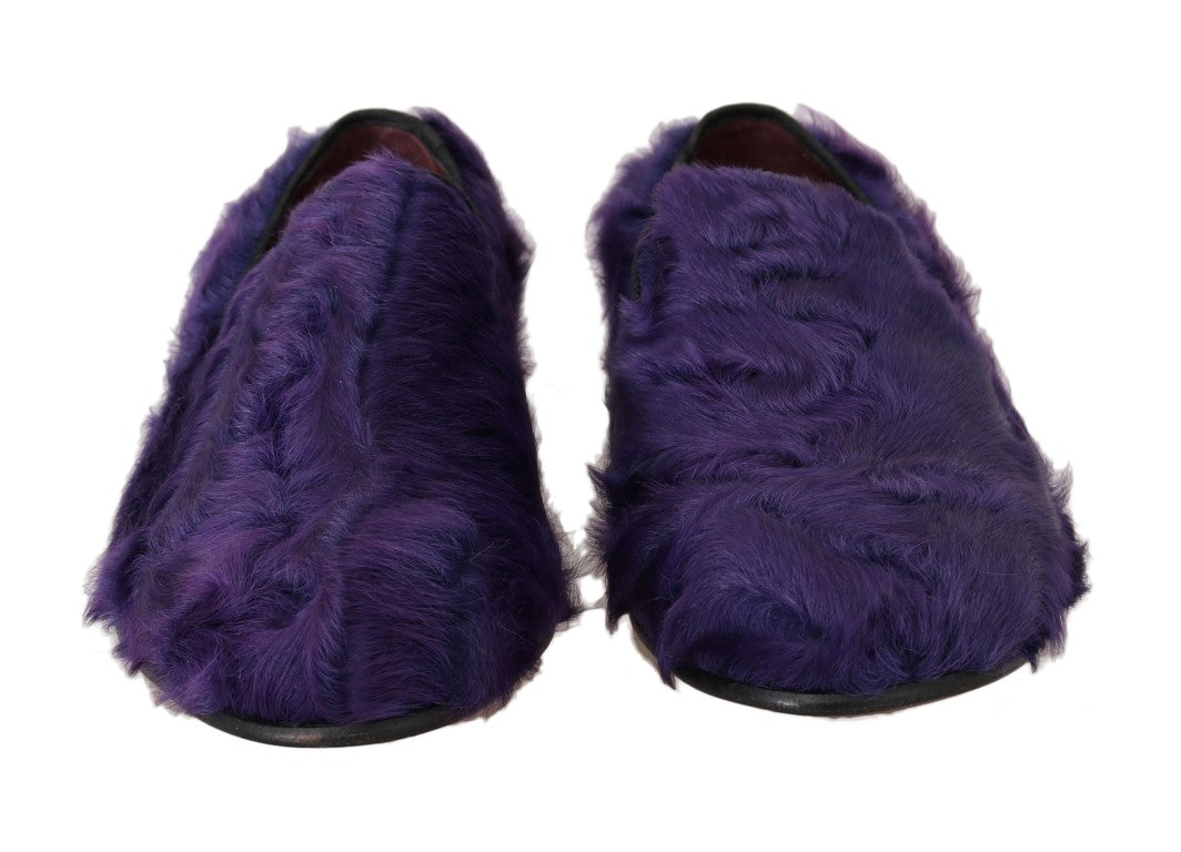 Pair of purple furry slippers with black soles