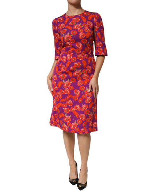 A woman wearing a purple floral print midi dress with short sleeves and a sheath silhouette