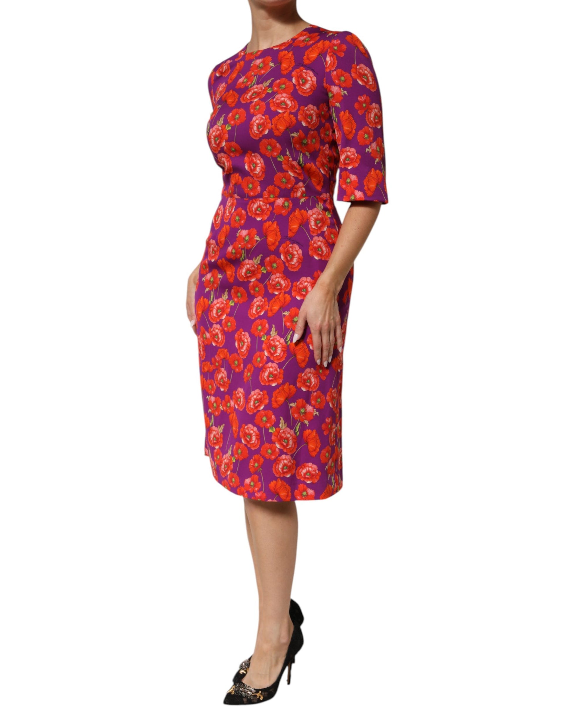 A woman wearing a red floral print midi dress with short sleeves