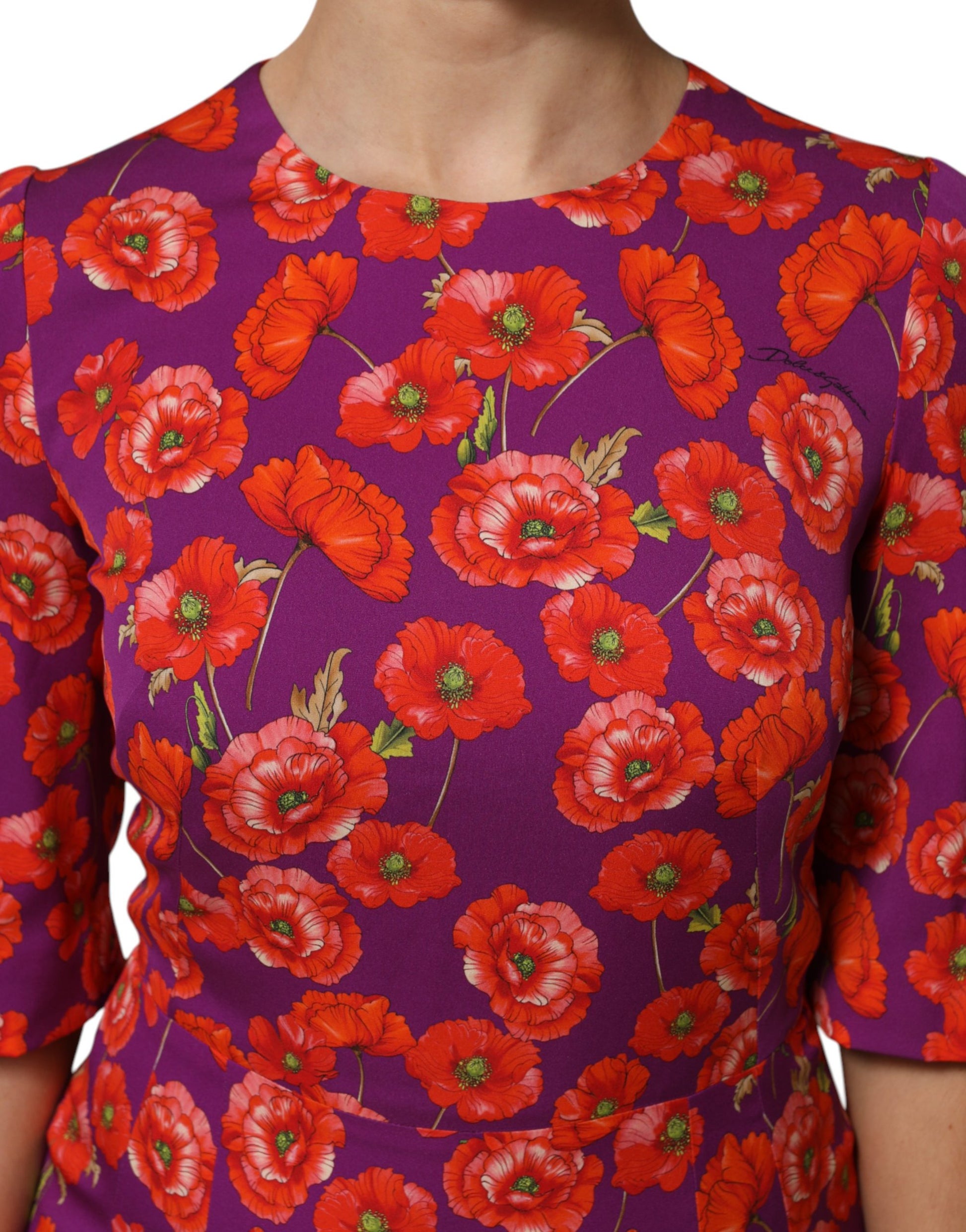 A purple silk midi sheath dress with a floral print