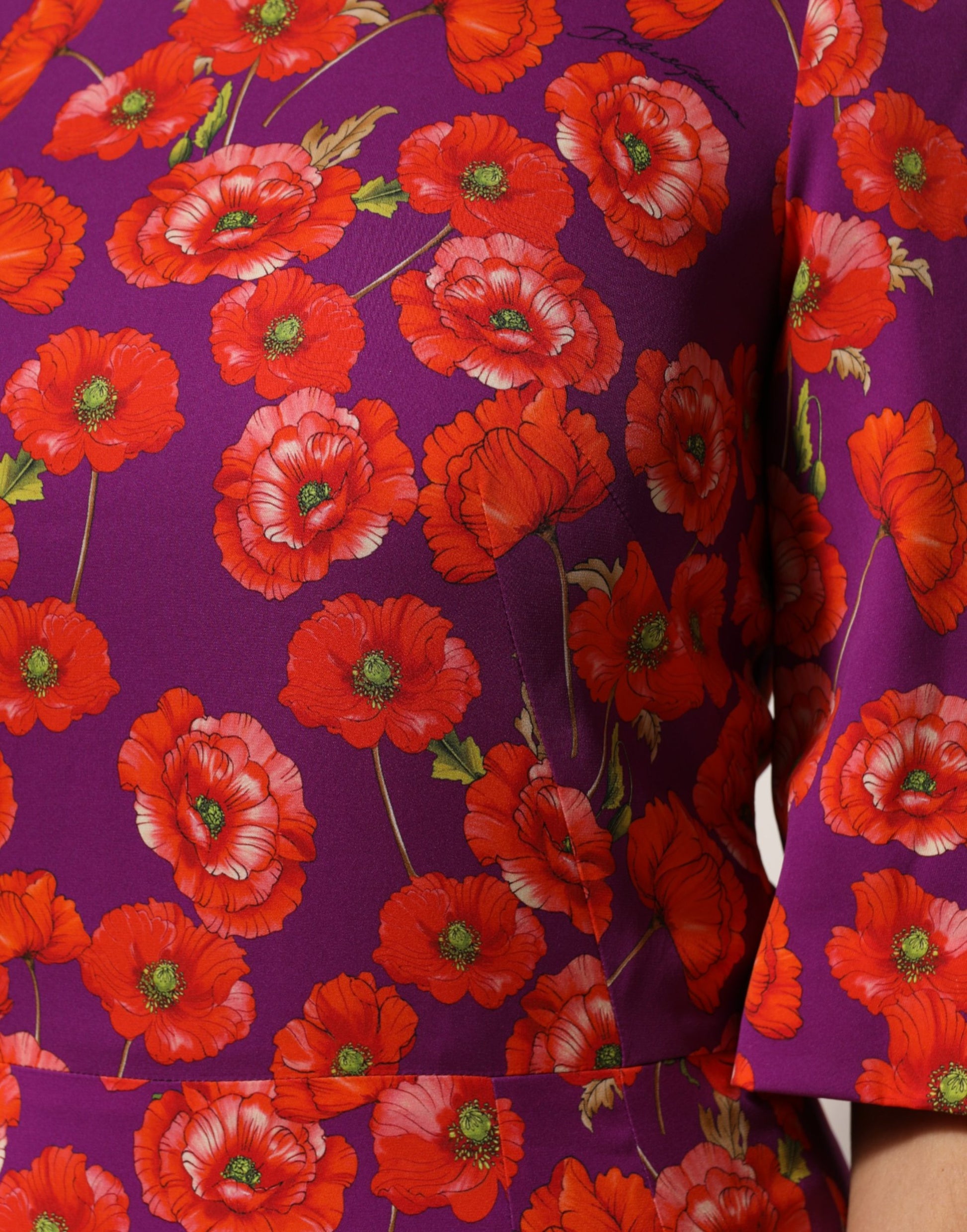 A purple silk midi sheath dress with a floral print featuring red flowers