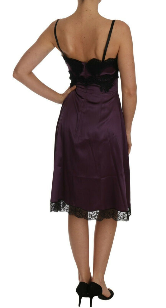 A purple silk stretch dress with black lace detailing. It is an A-line style, featuring a backless design and