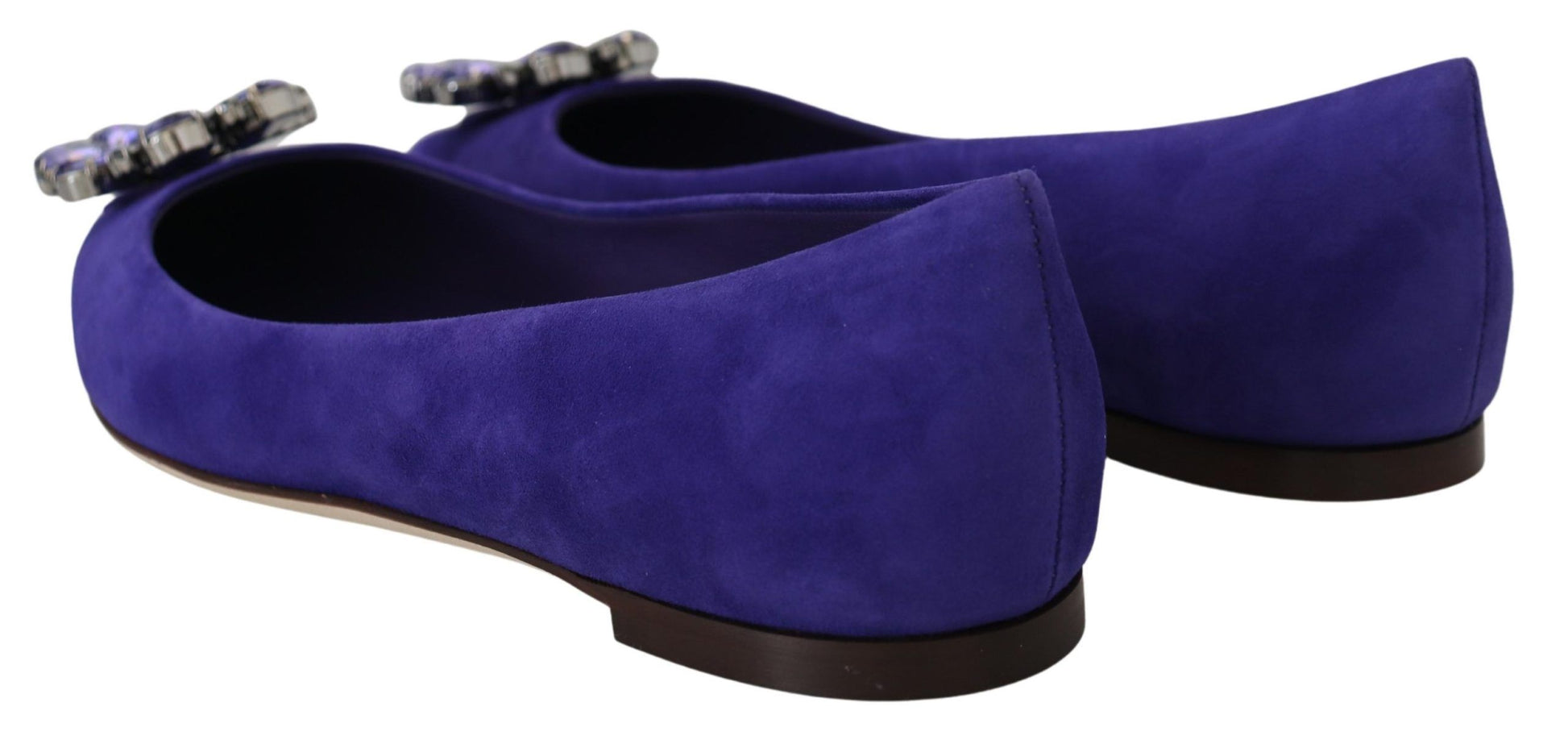 Pair of purple velvet shoes with heels and bows on top