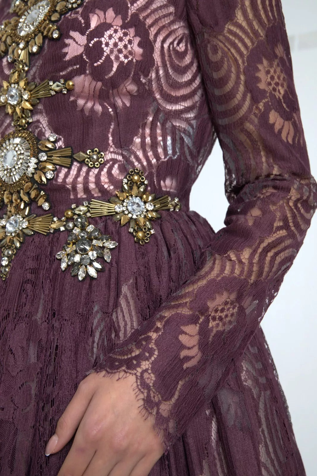 A purple viscose dress with crystal embellishments. It features an A-line silhouette and is designed by Dolce