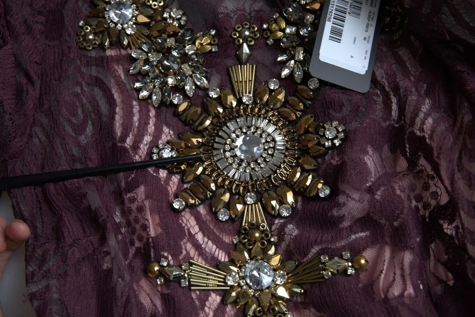 Gold embellished necklace on purple dress