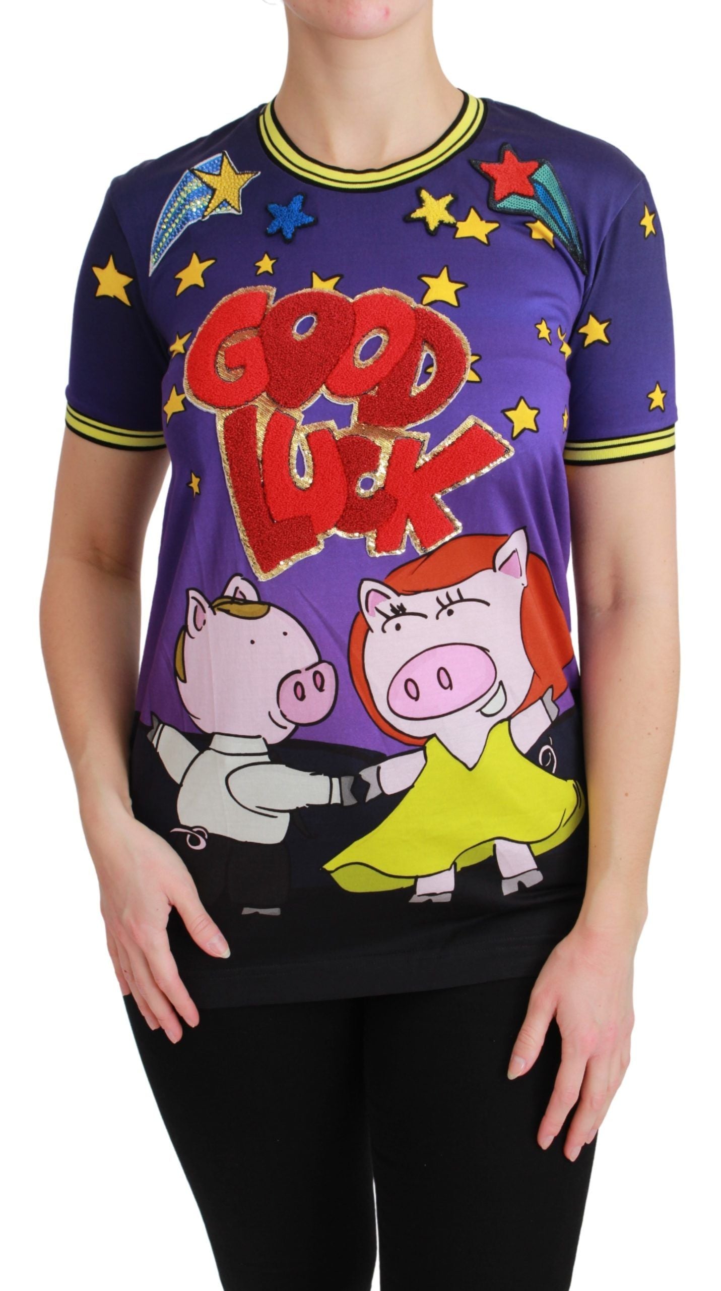 Woman wearing a purple t-shirt with cartoon pigs on it