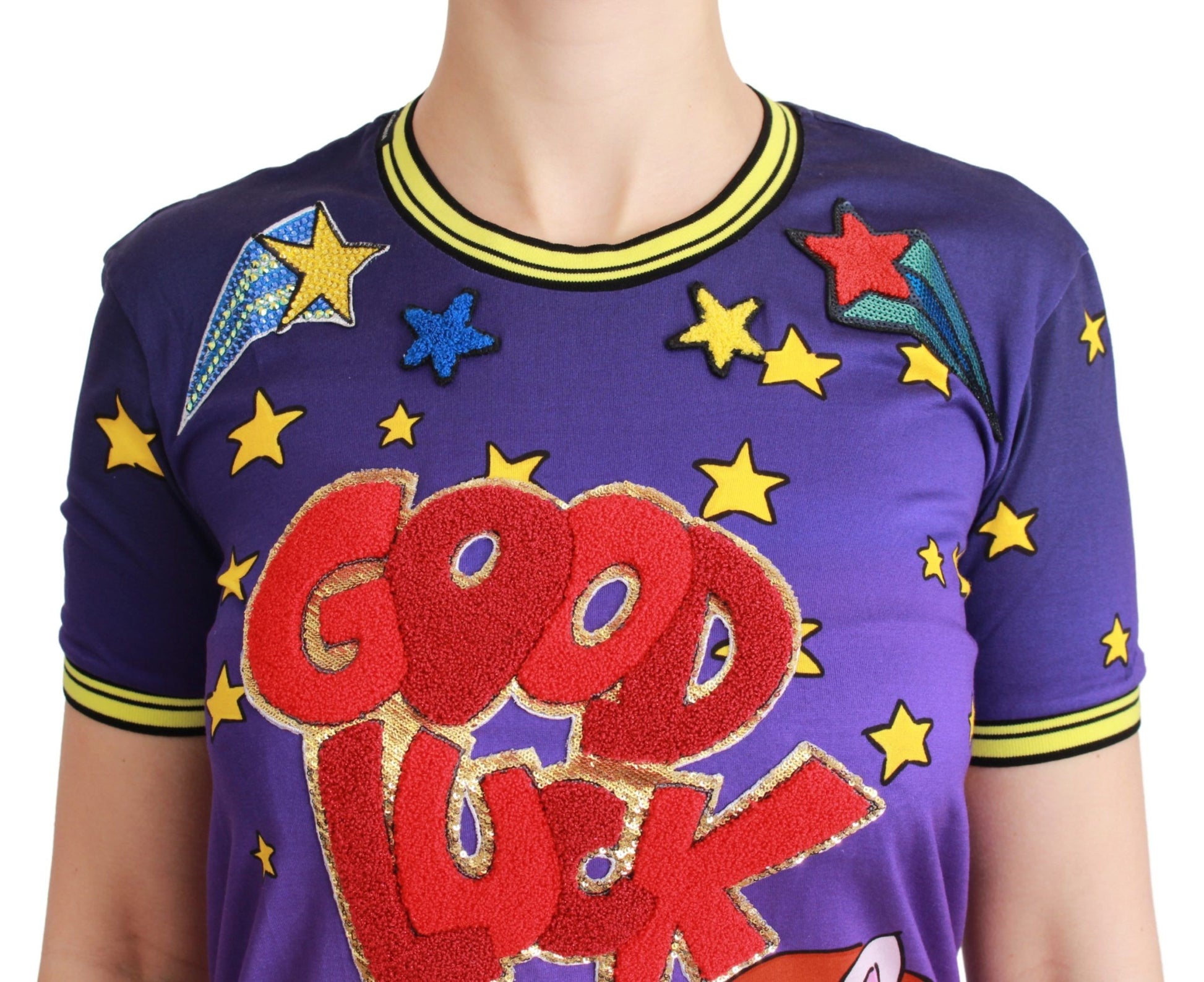 Purple shirt with stars and "good luck" written in red letters