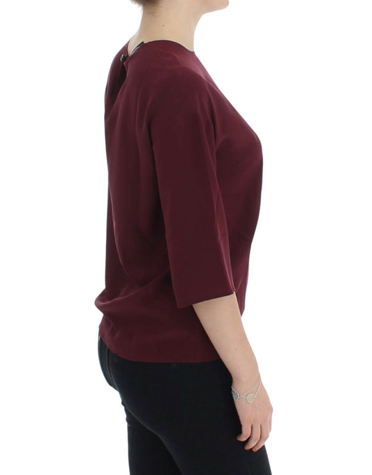 Woman wearing burgundy top and black pants