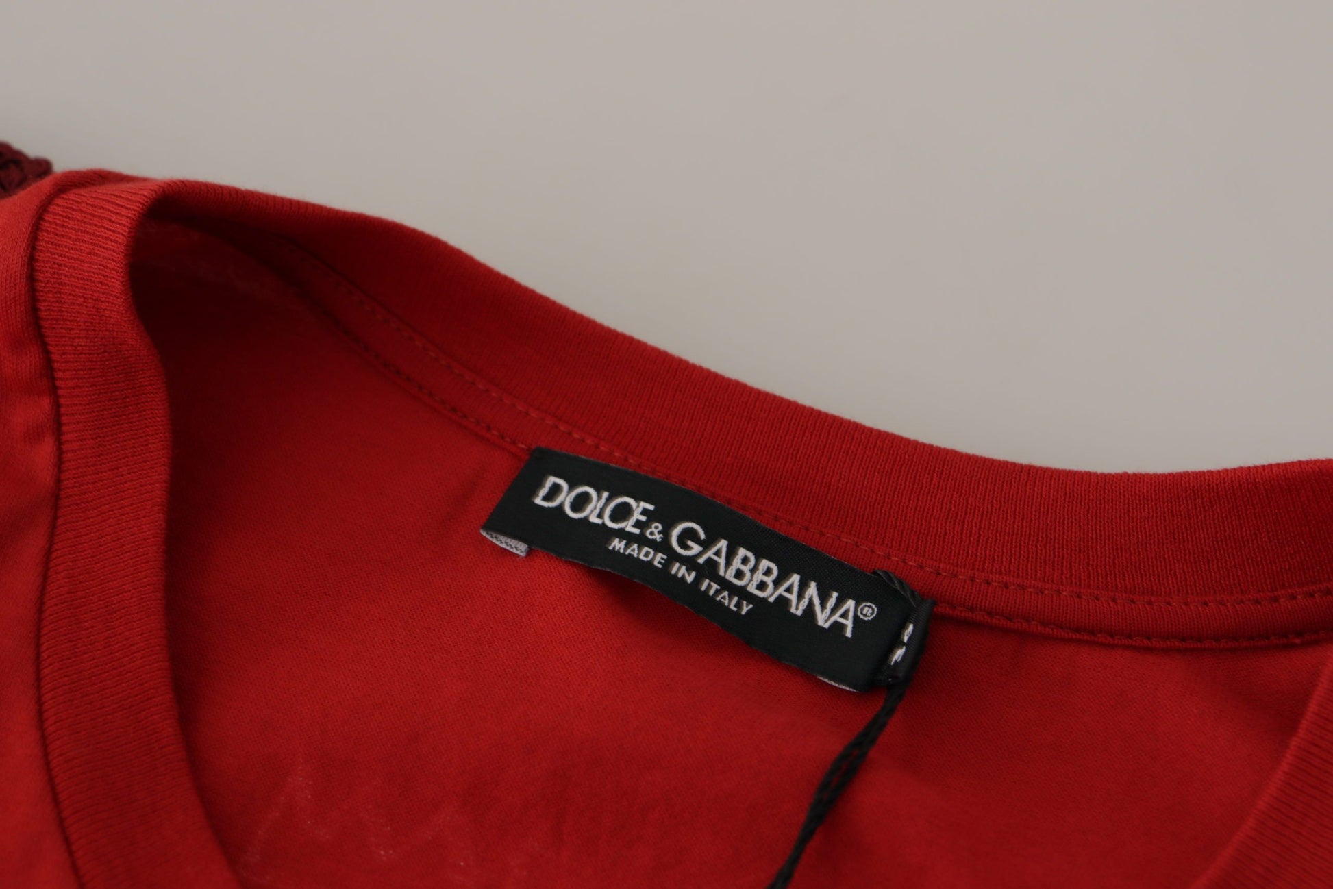 Red t-shirt on hanger with black label