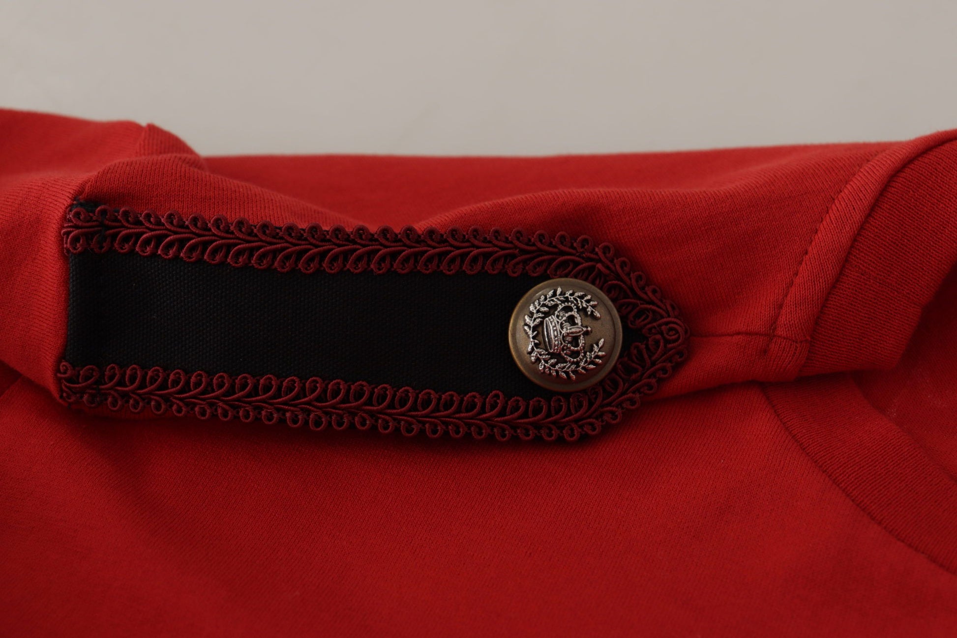 Red jacket with black trim and embroidered emblem on sleeve