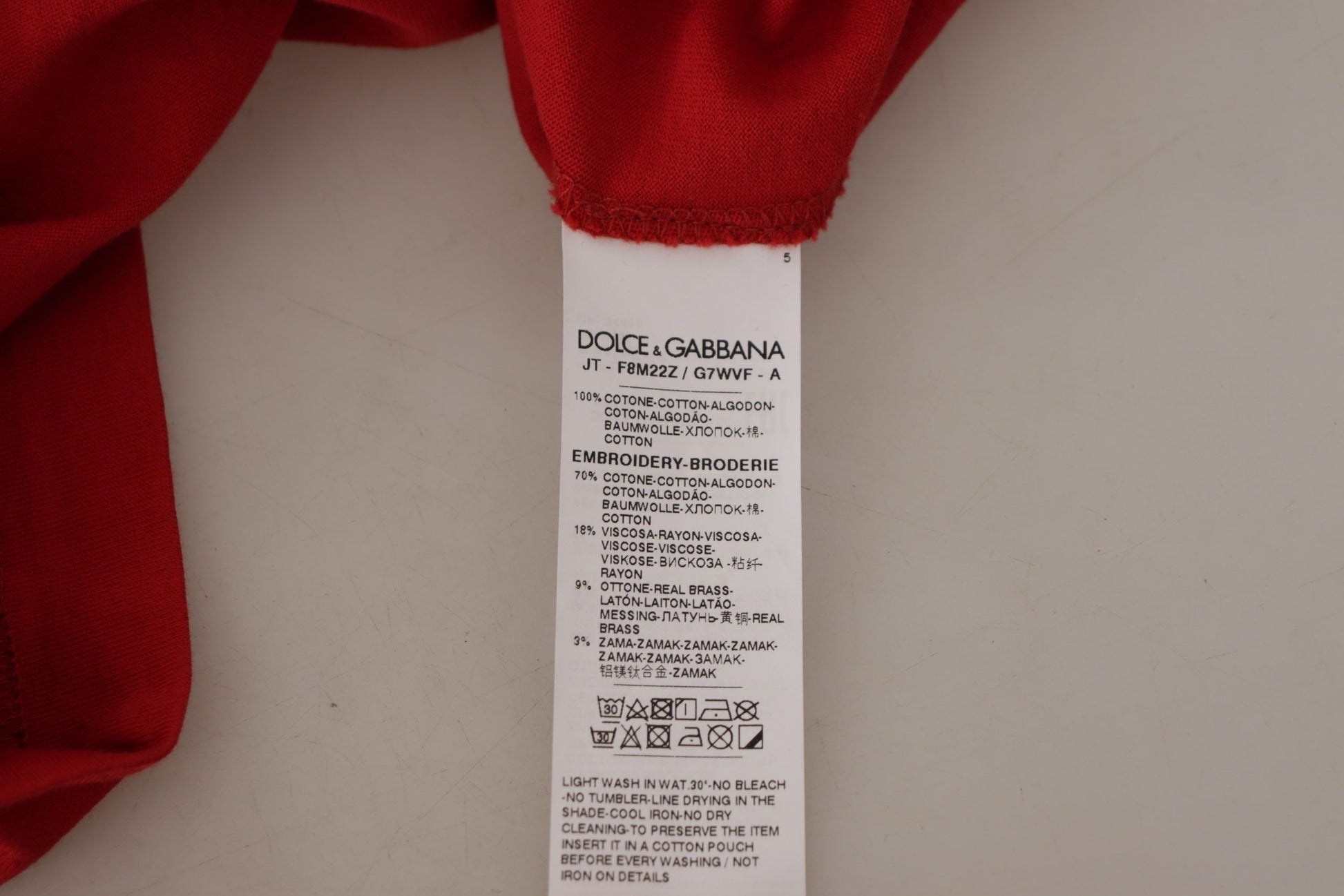 Red fabric tagged with white label containing text