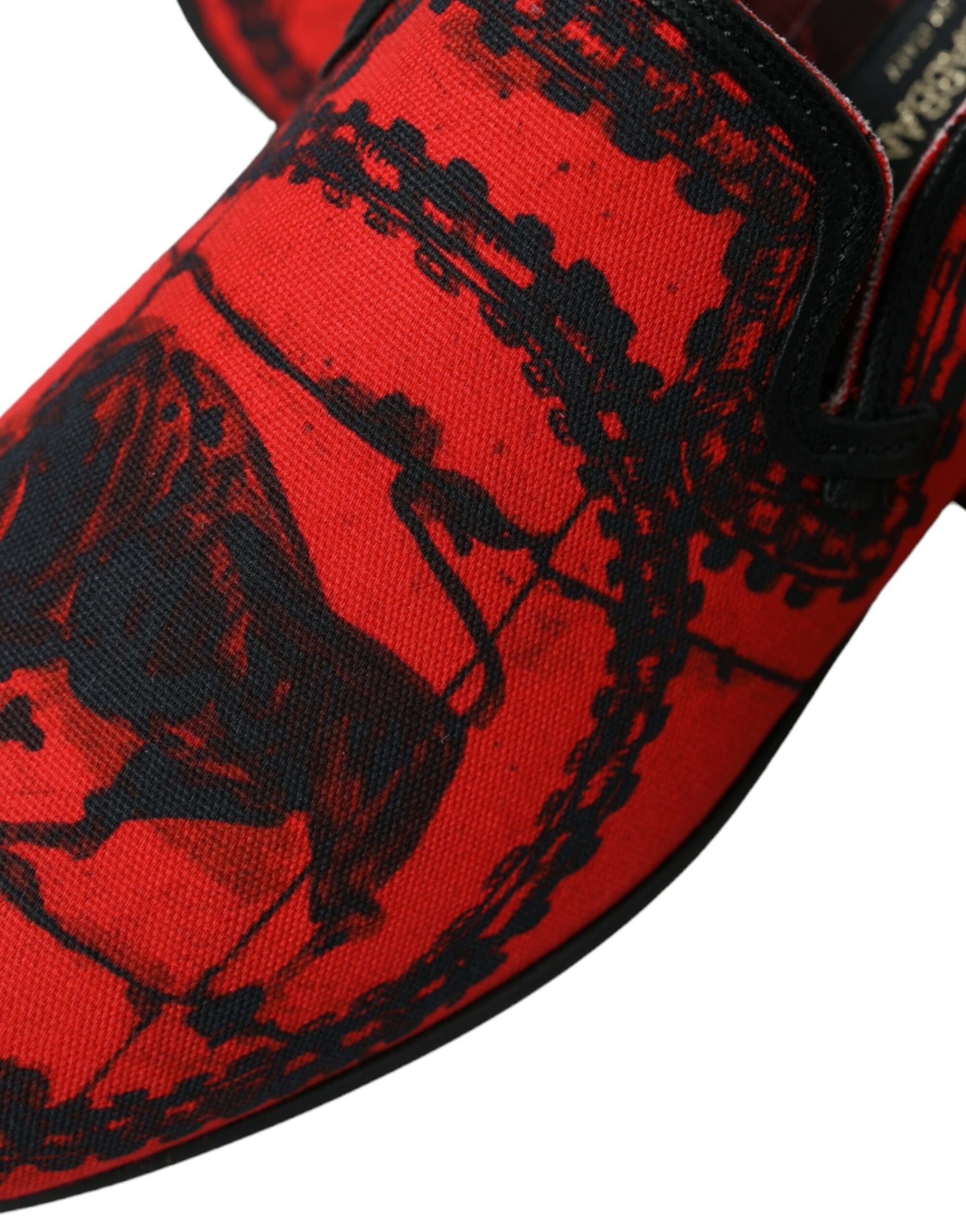 Red shoe with black laces and a patterned design on the side