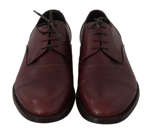 Pair of brown leather shoes with laces and a small heel
