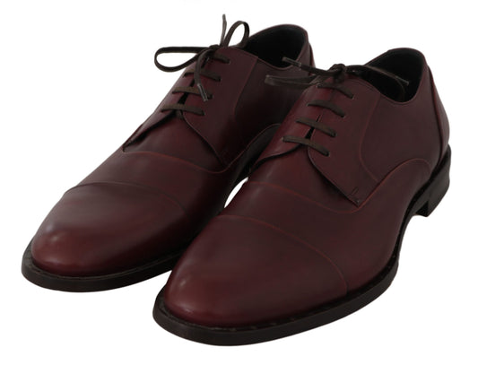 Pair of red leather lace-up shoes with black soles and laces