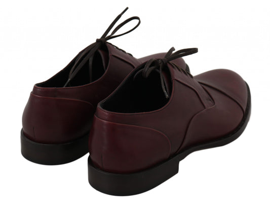 Pair of burgundy lace-up shoes with black soles and laces