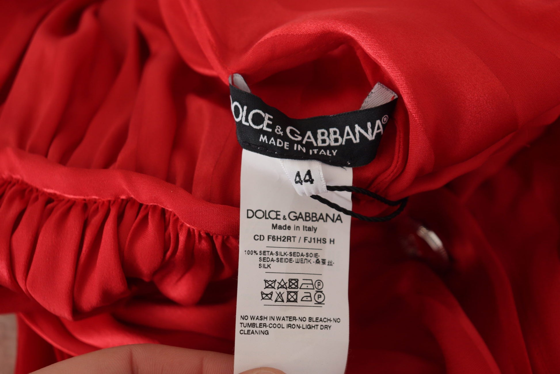 A red satin silk midi dress with a belt and button detail