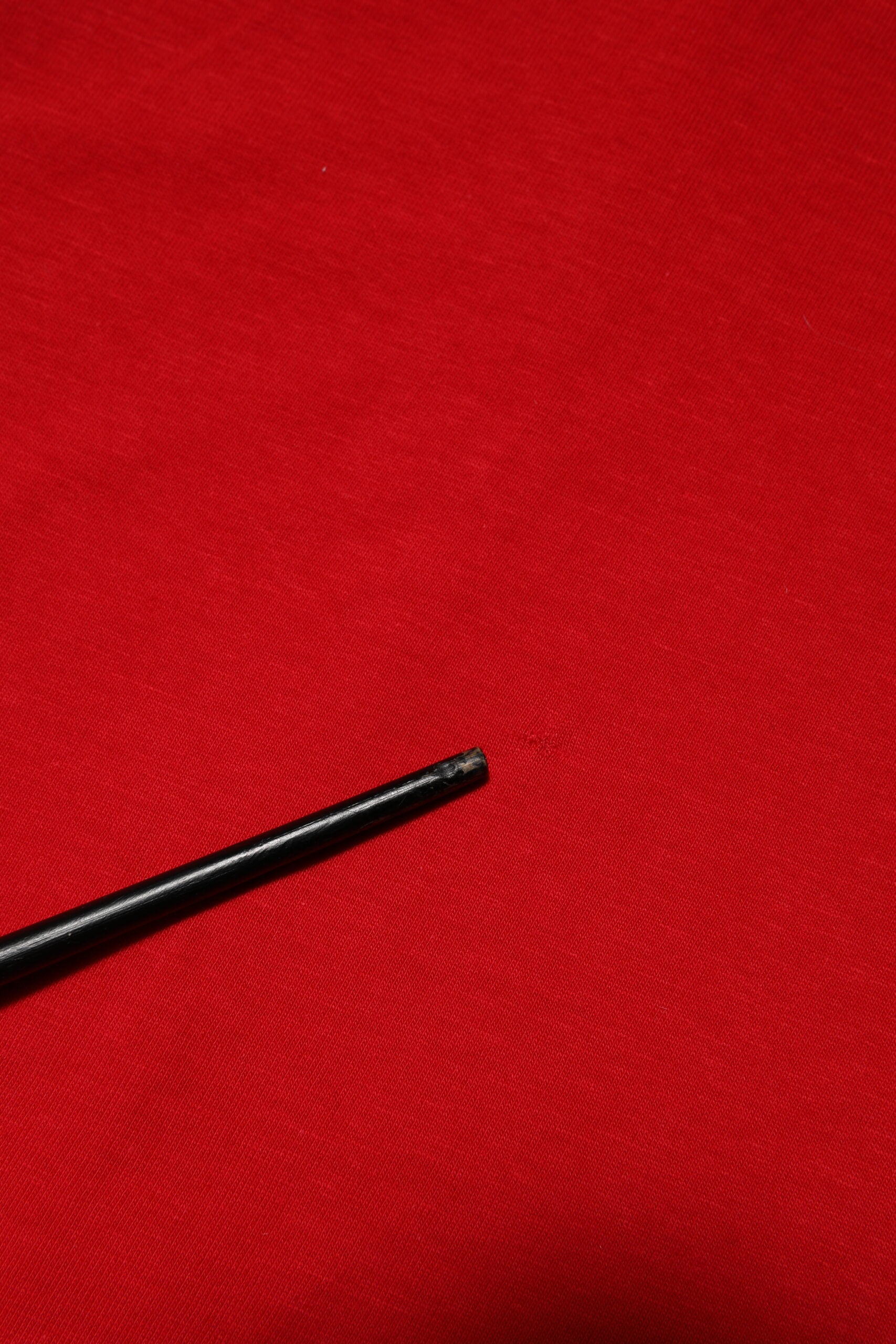 Black pen on red surface