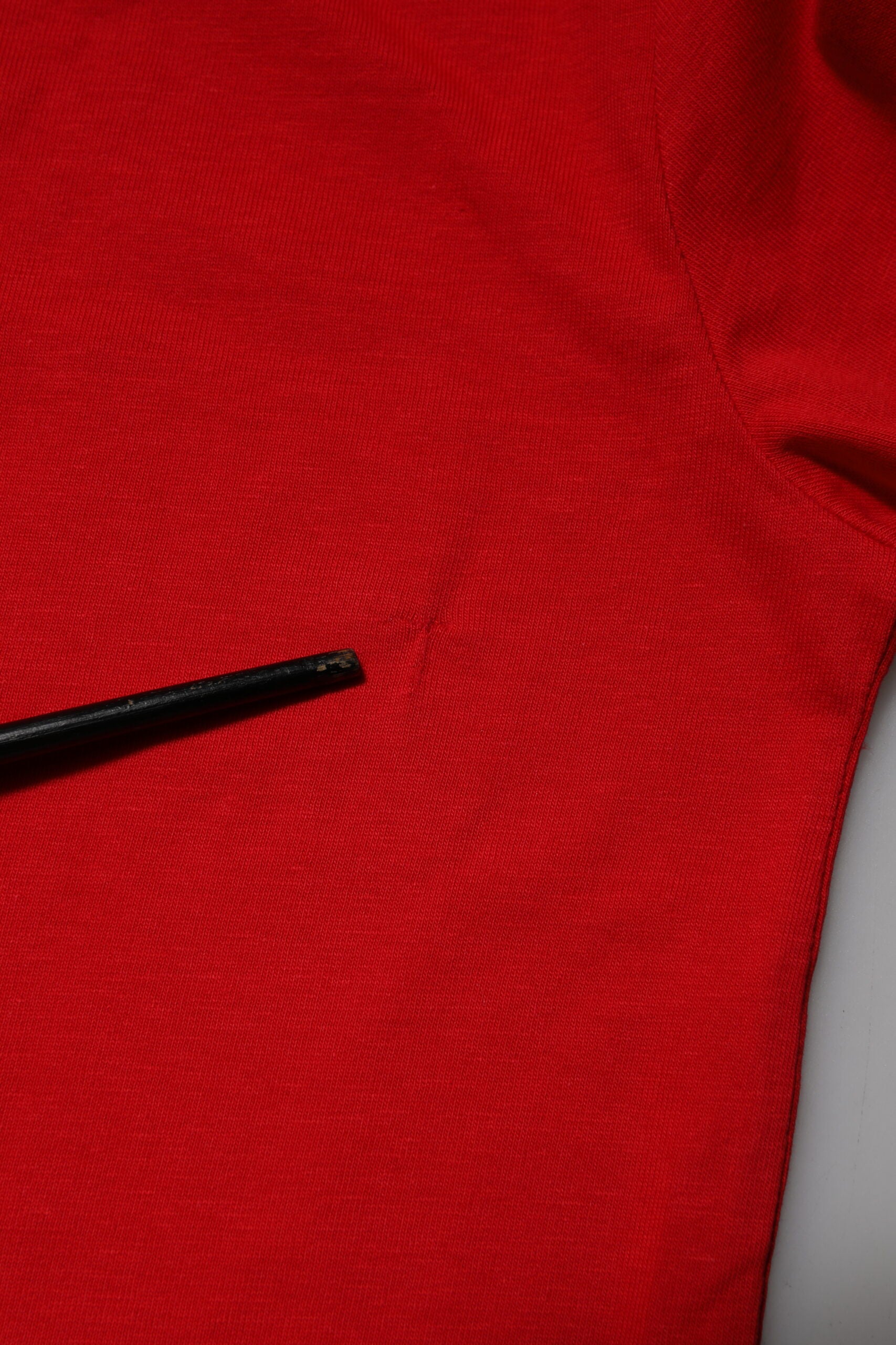 Black pen on red fabric