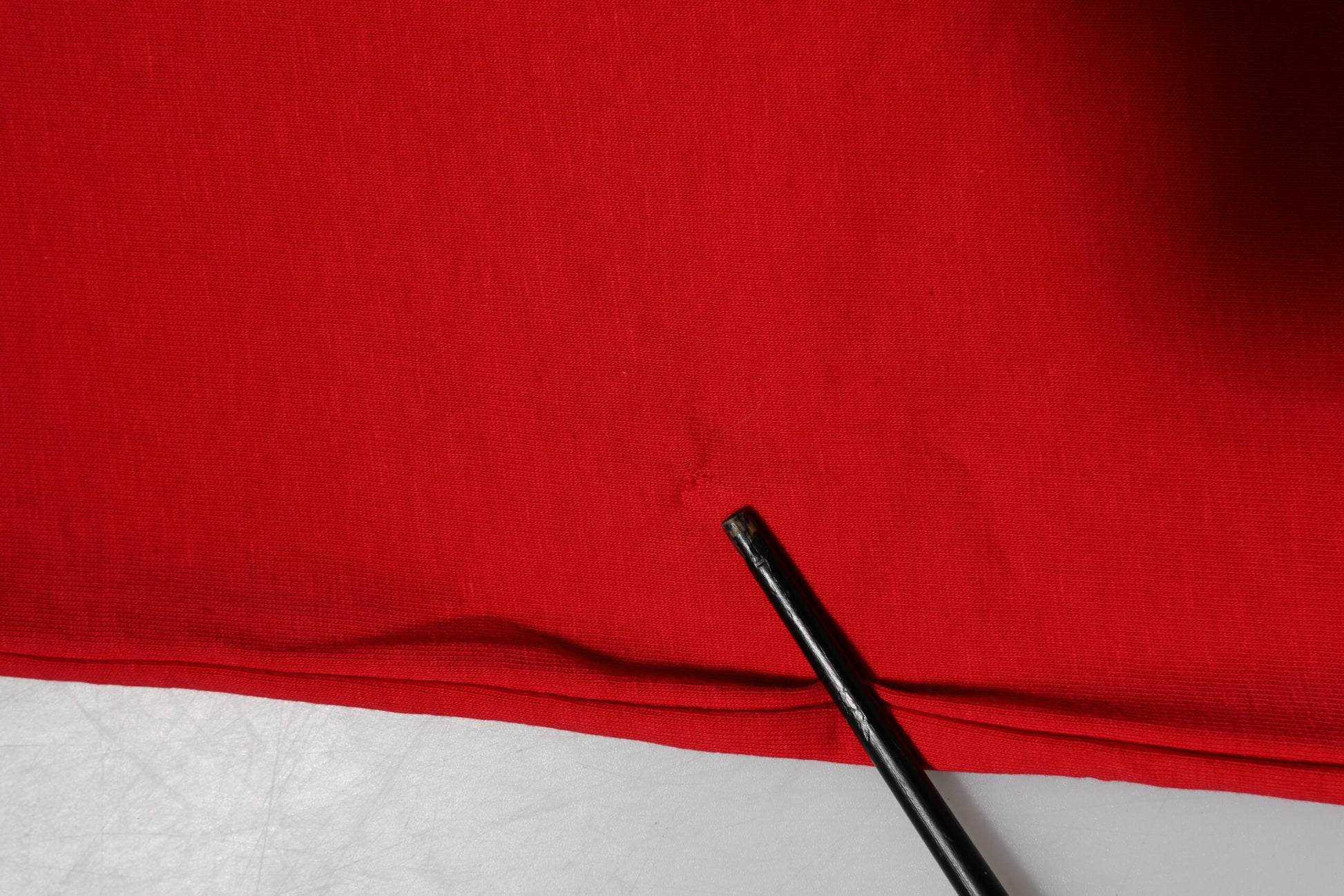 Black pen on red fabric