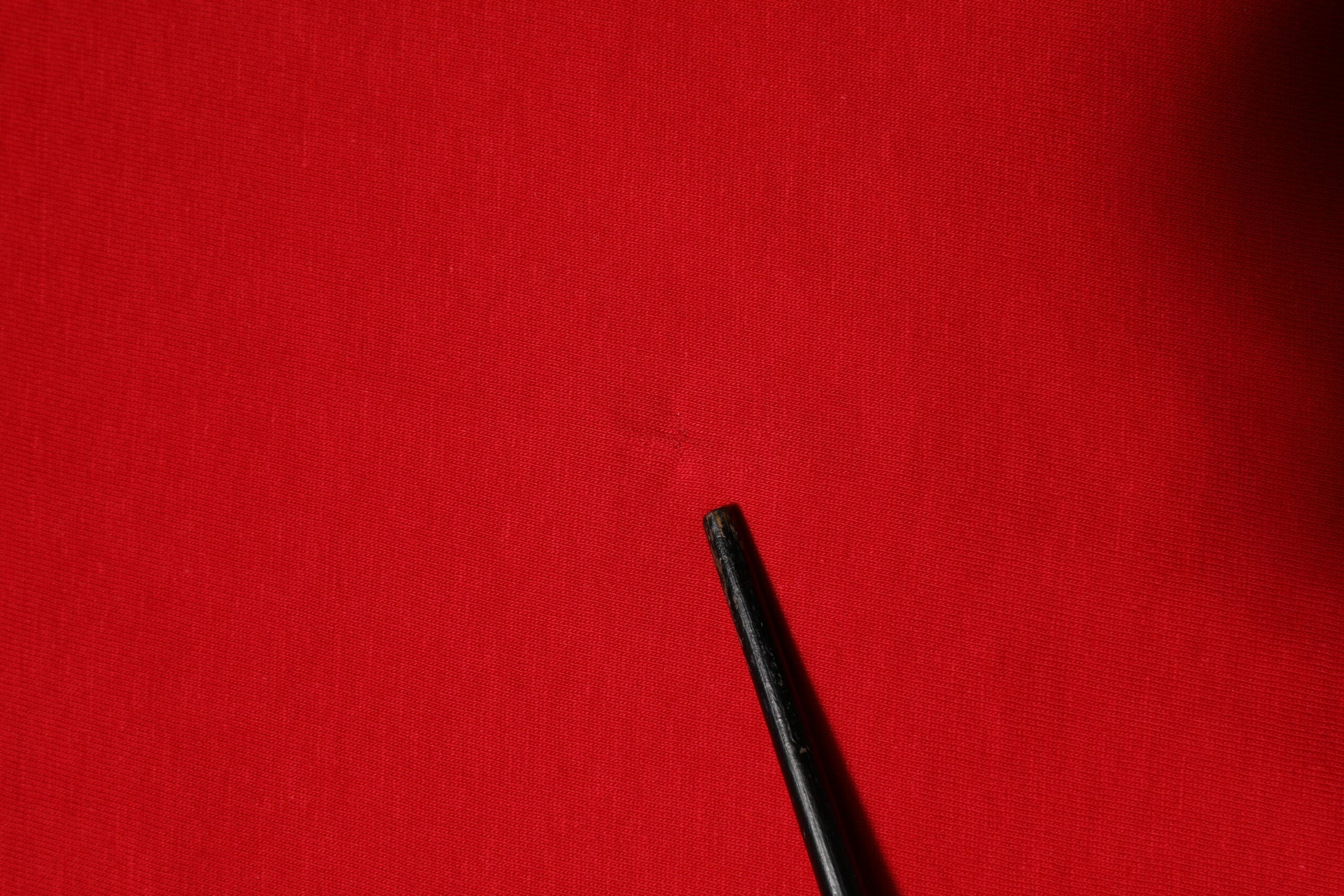 Black pen on red surface