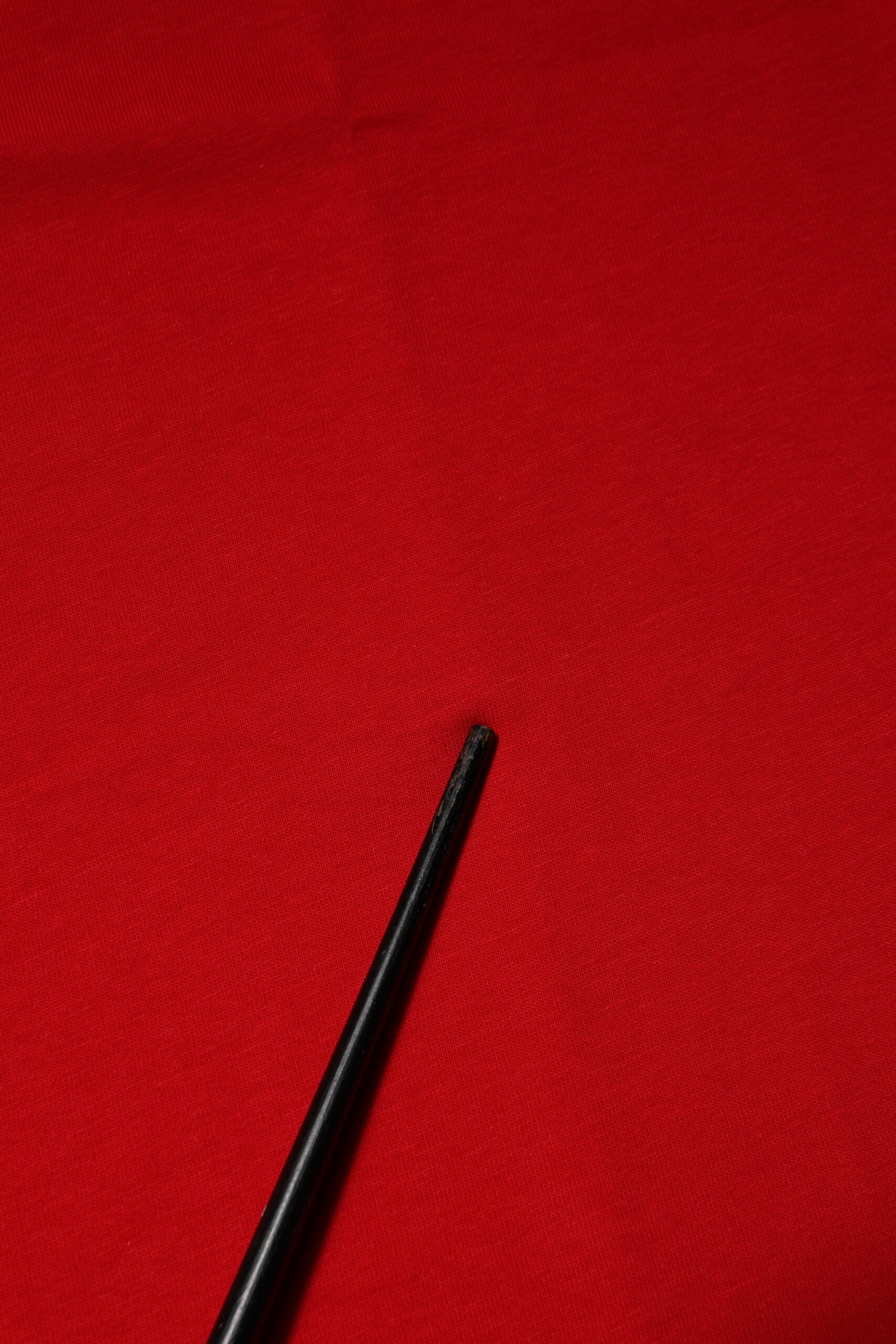 Black pen on red fabric
