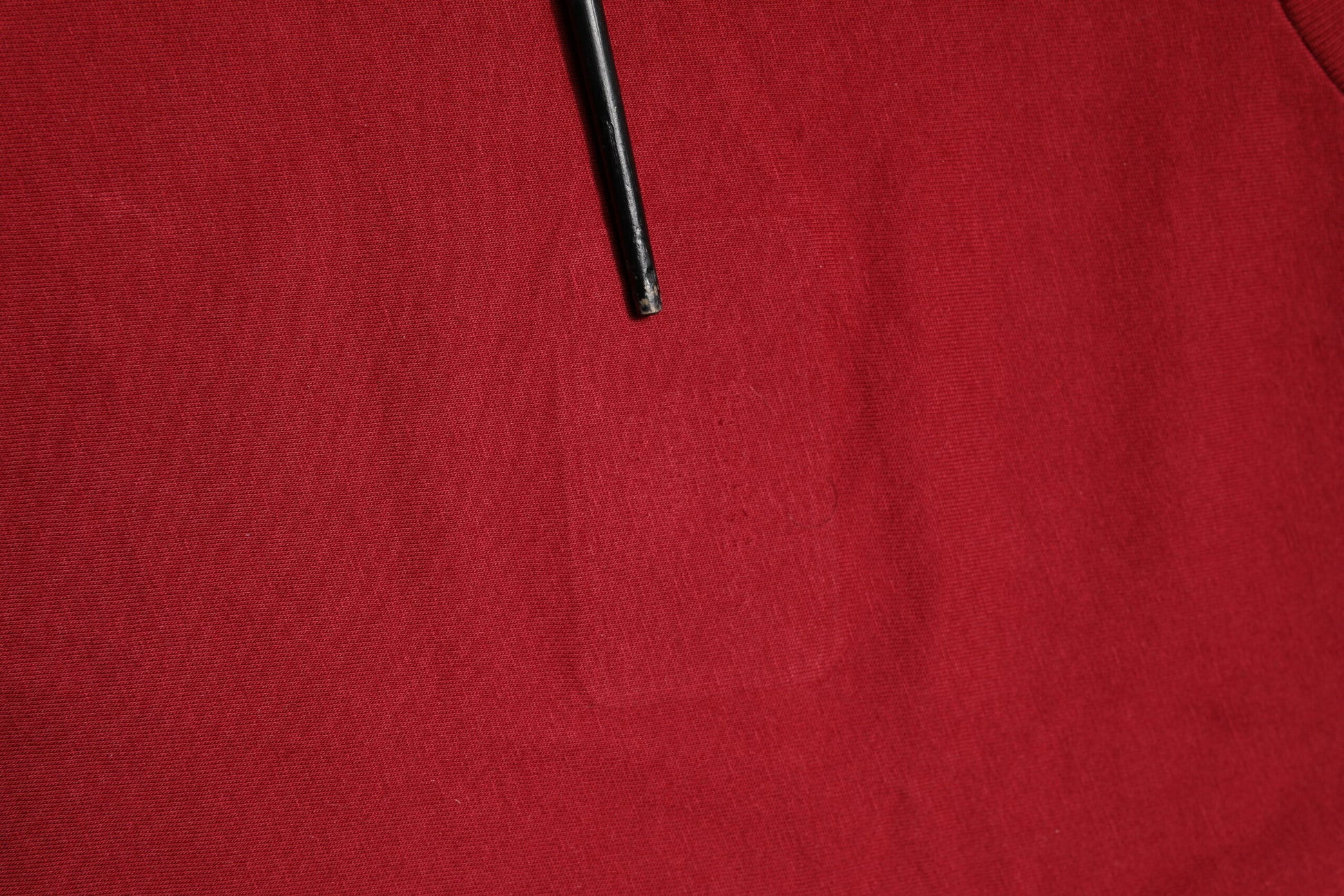 Black pen on red fabric