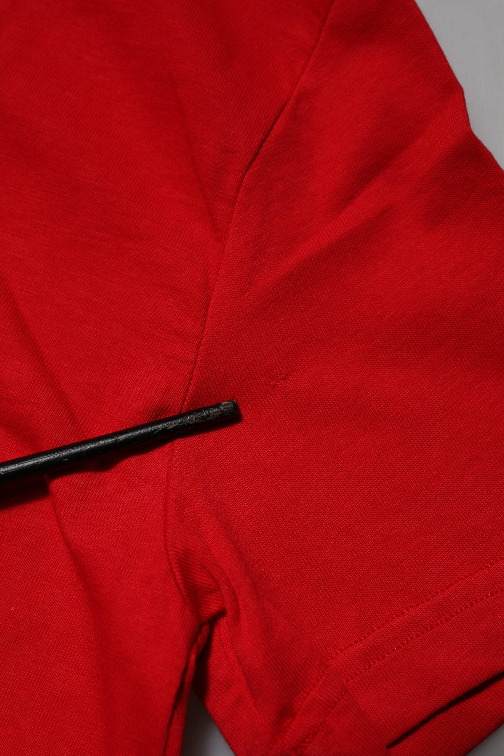 Red shirt with black button