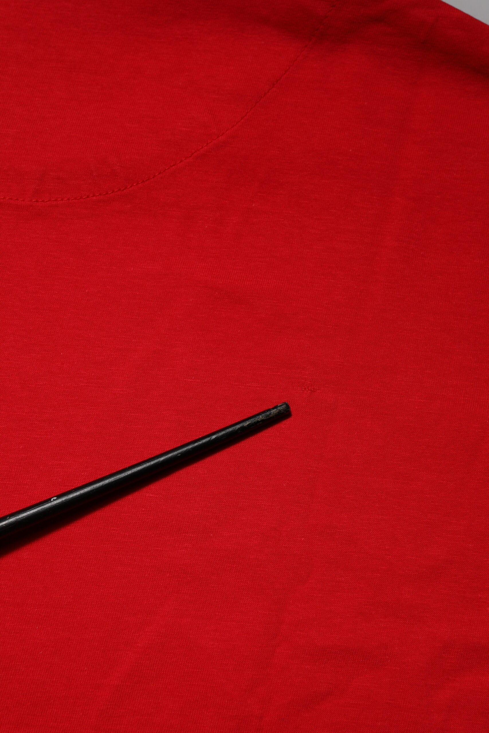 Black chopsticks on red fabric surface