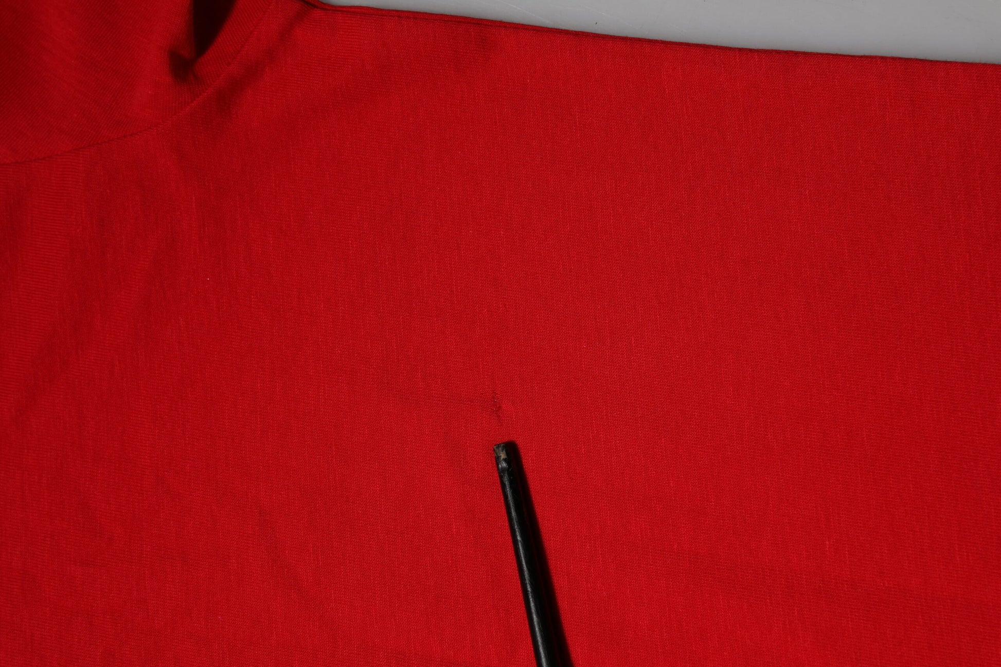 Black pen on red fabric