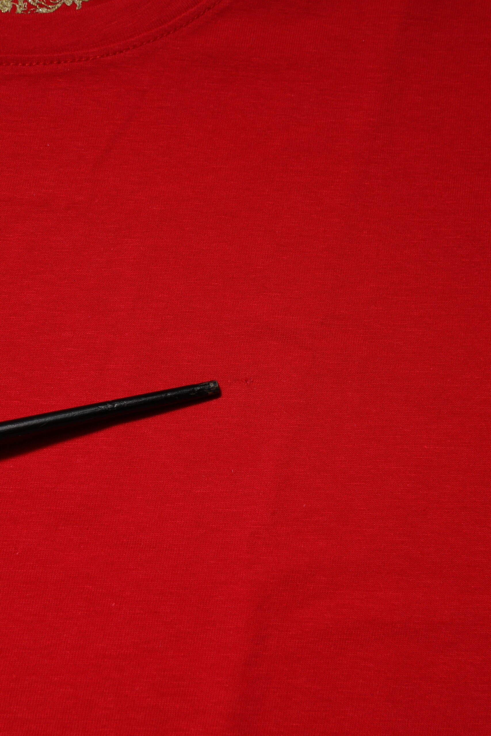 Red shirt with black pen marking