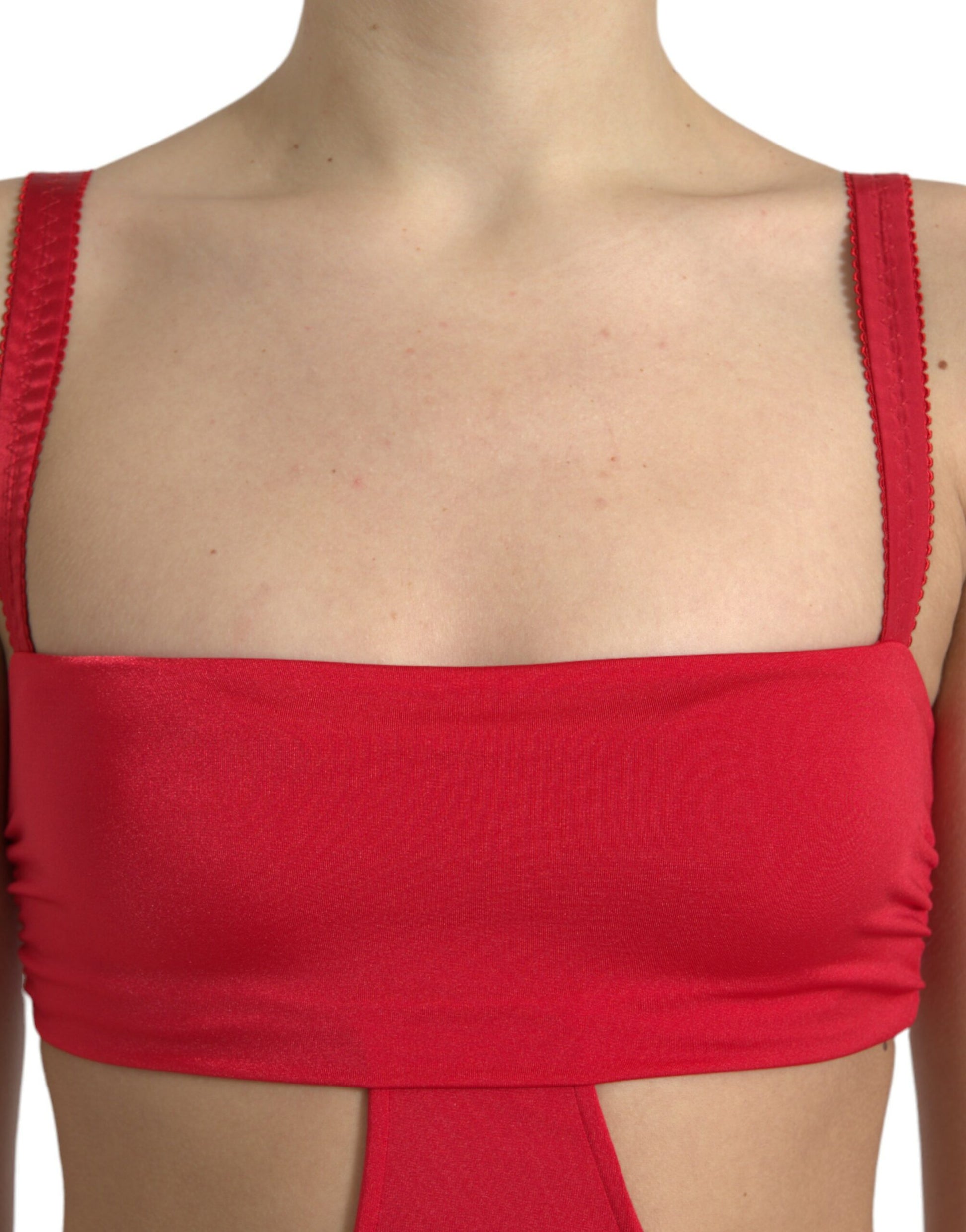 A red sleeveless dress with cutouts and a sheer nylon fabric