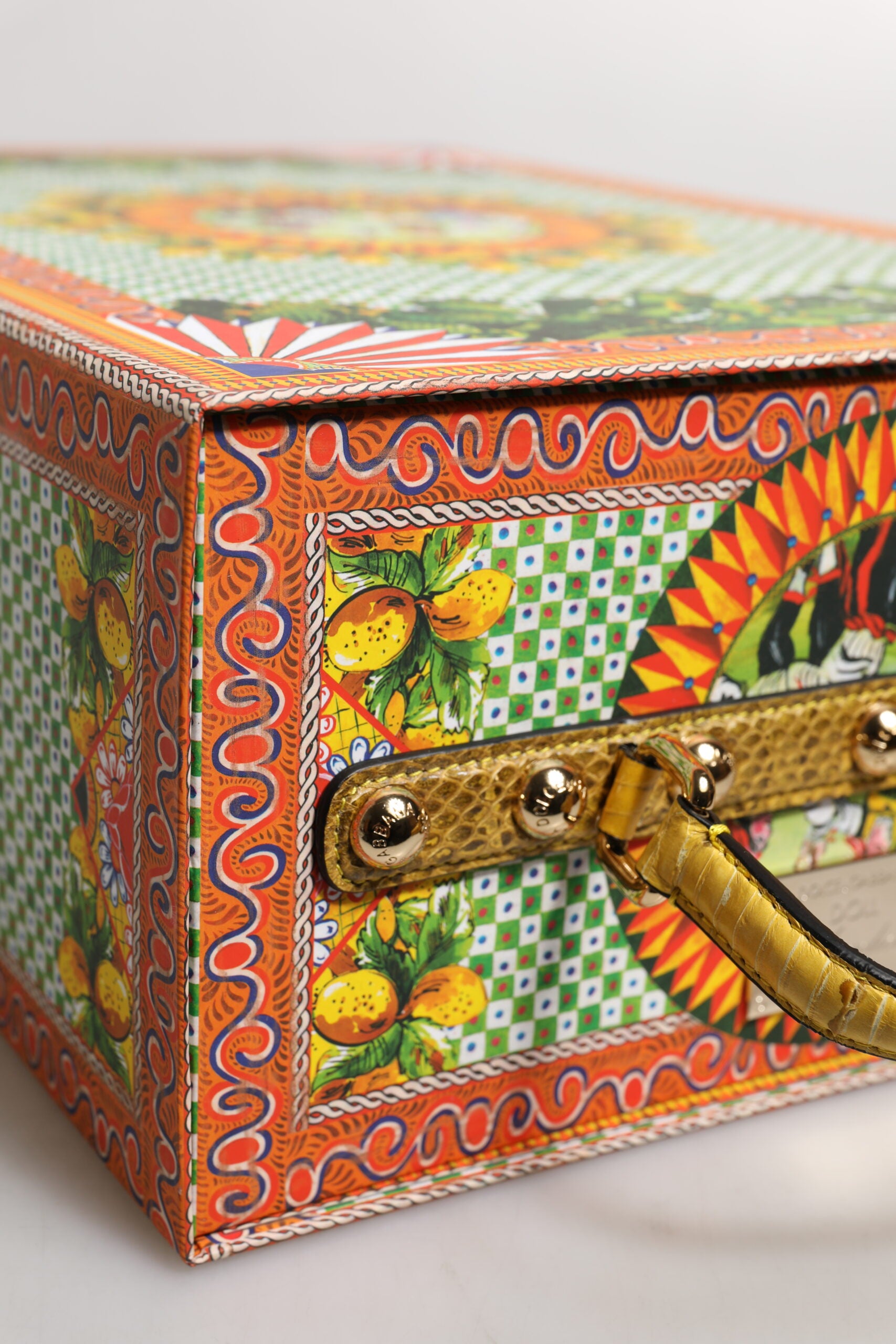 Colorful ceramic box with floral design, gold clasp and handle