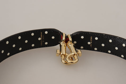 Black belt with gold buckle featuring a red gemstone