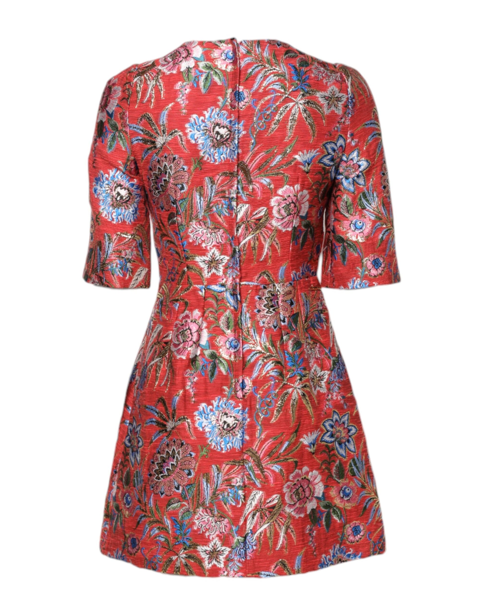 A red floral jacquard dress with an A-line silhouette. It features a vibrant pattern of flowers and leaves on
