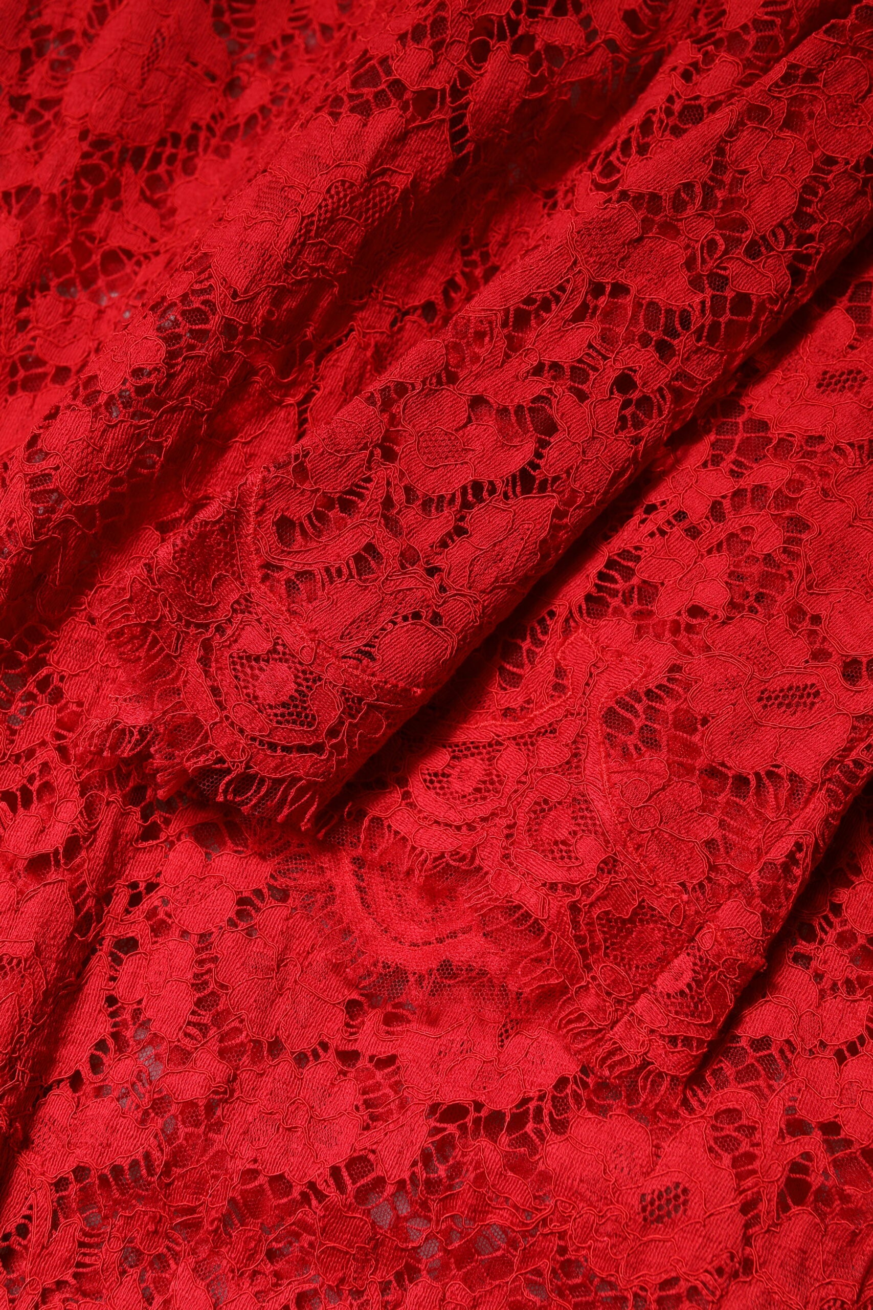 A red lace dress with rhinestones and floral embellishments