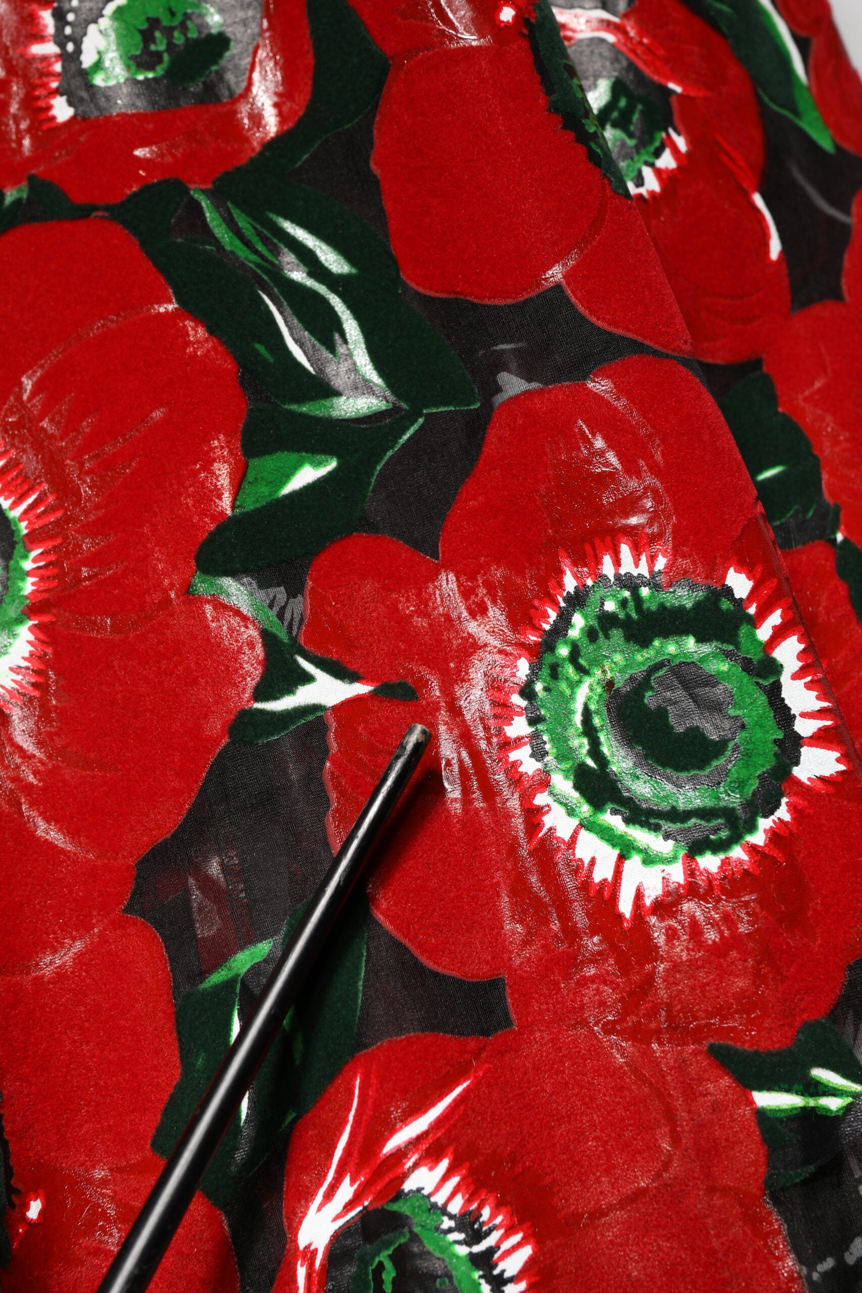 A red floral print nylon dress with an A-line silhouette