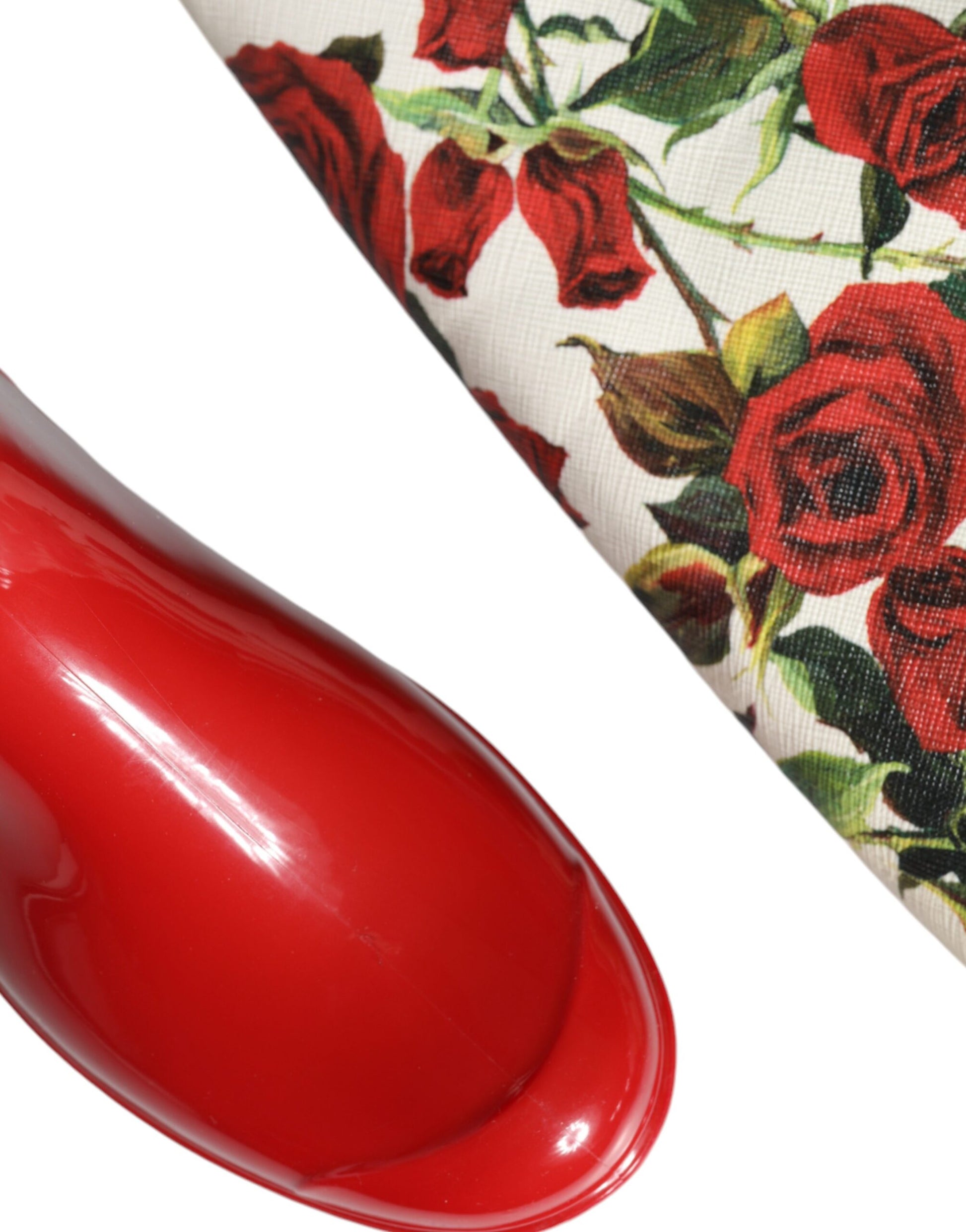 Red nail polish bottle on fabric with floral print