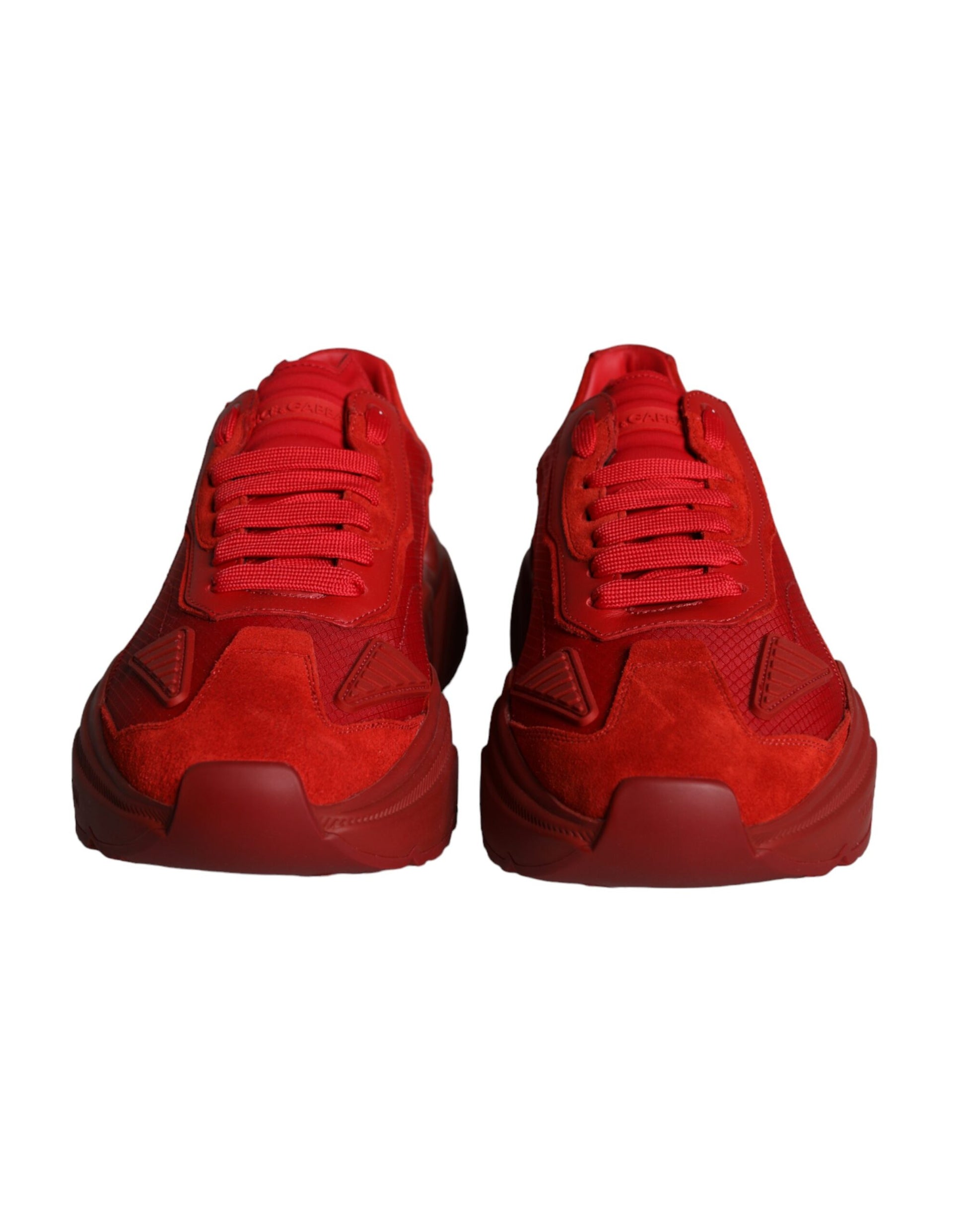 Pair of red leather sneakers with laces and a low top, featuring the Dolce & Gabbana logo
