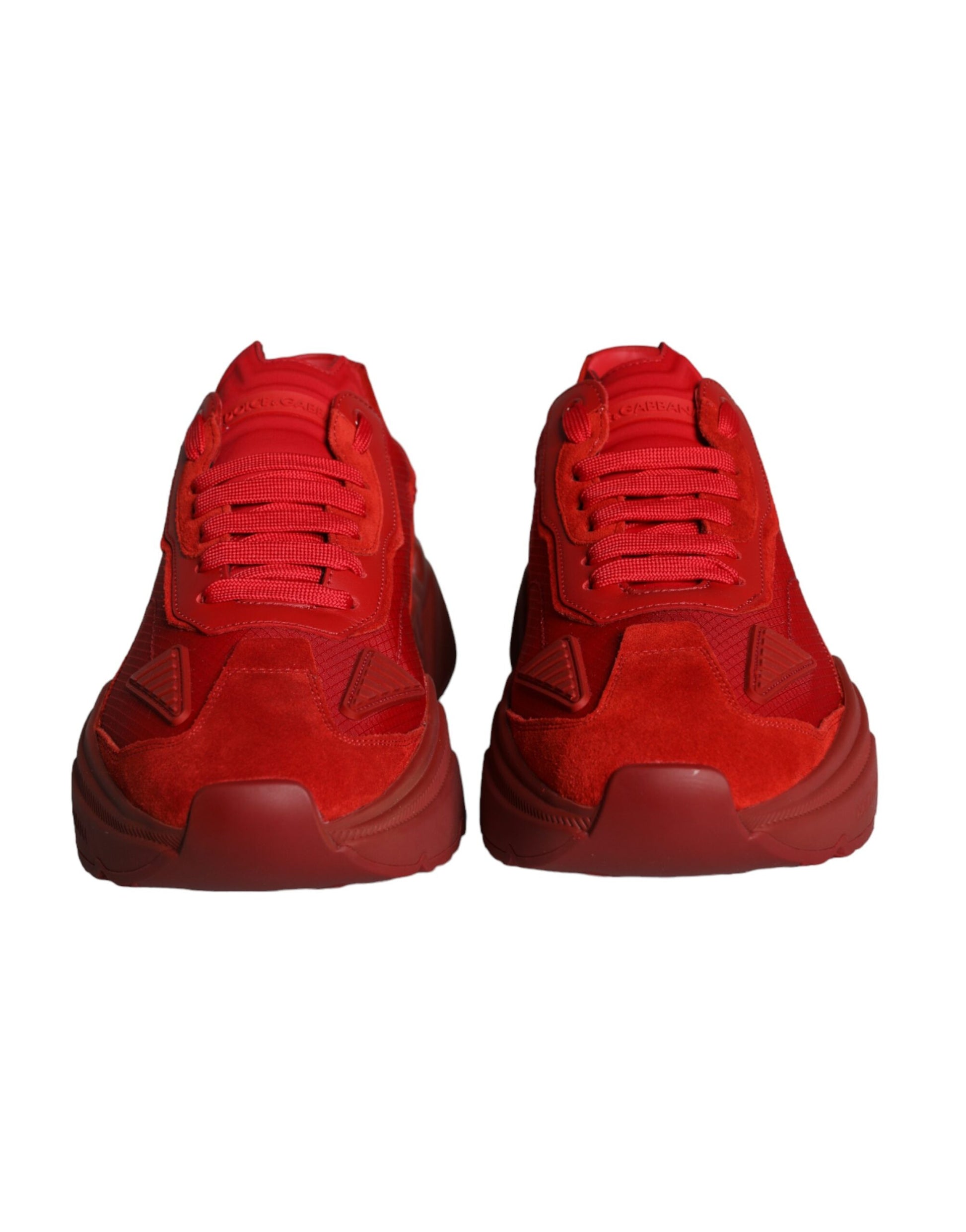 Pair of red leather sneakers with white soles, laces and logo