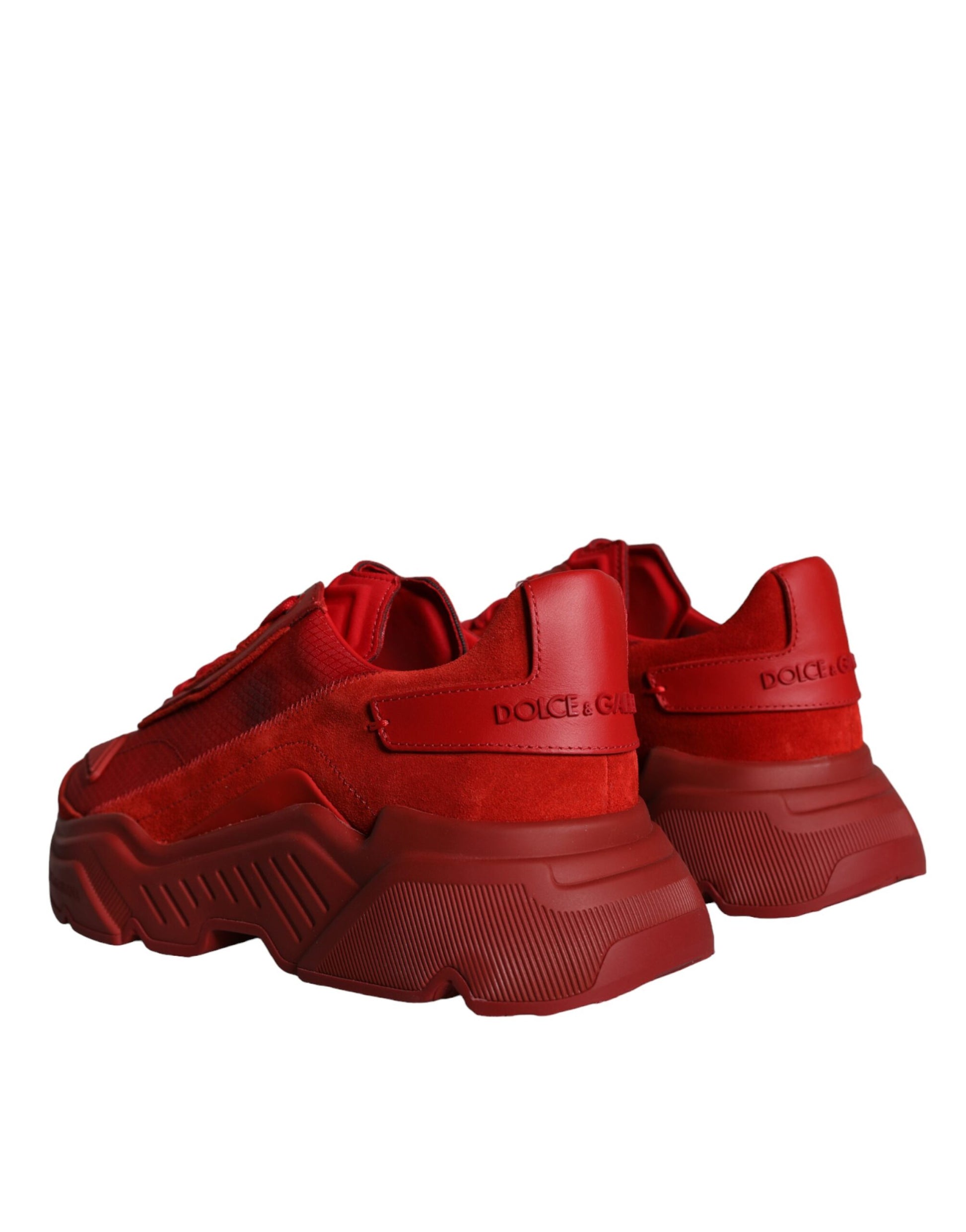 A pair of red leather sneakers with a low top, featuring the brand name "Dolce & Gabbana" on the side