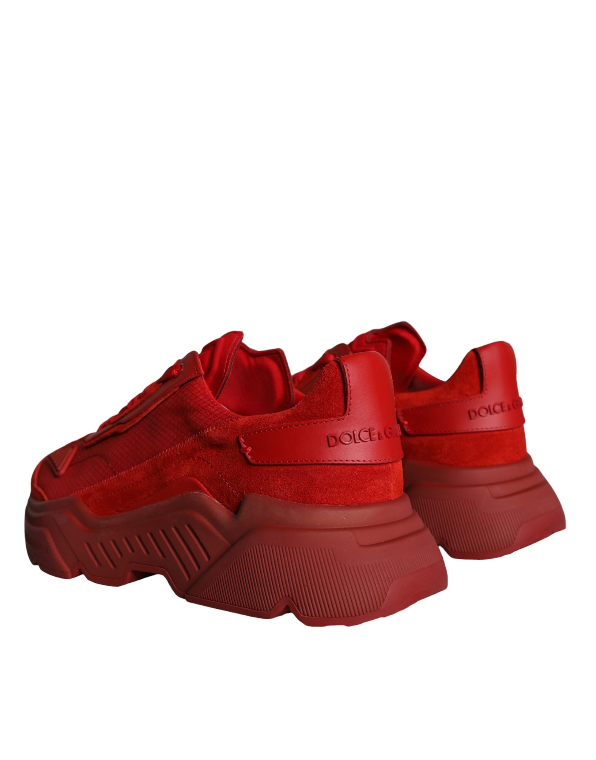 Pair of red leather sneakers with white soles and laces, featuring the Dolce & Gabbana logo
